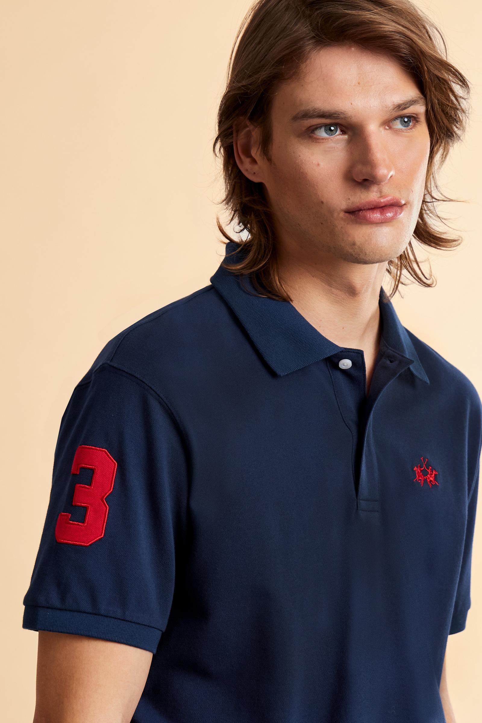 Men’s short-sleeve stretch piqué polo. Two-button placket and ribbed details, with a regular fit. Iconic style characterised by applied logo and patches. - Navy