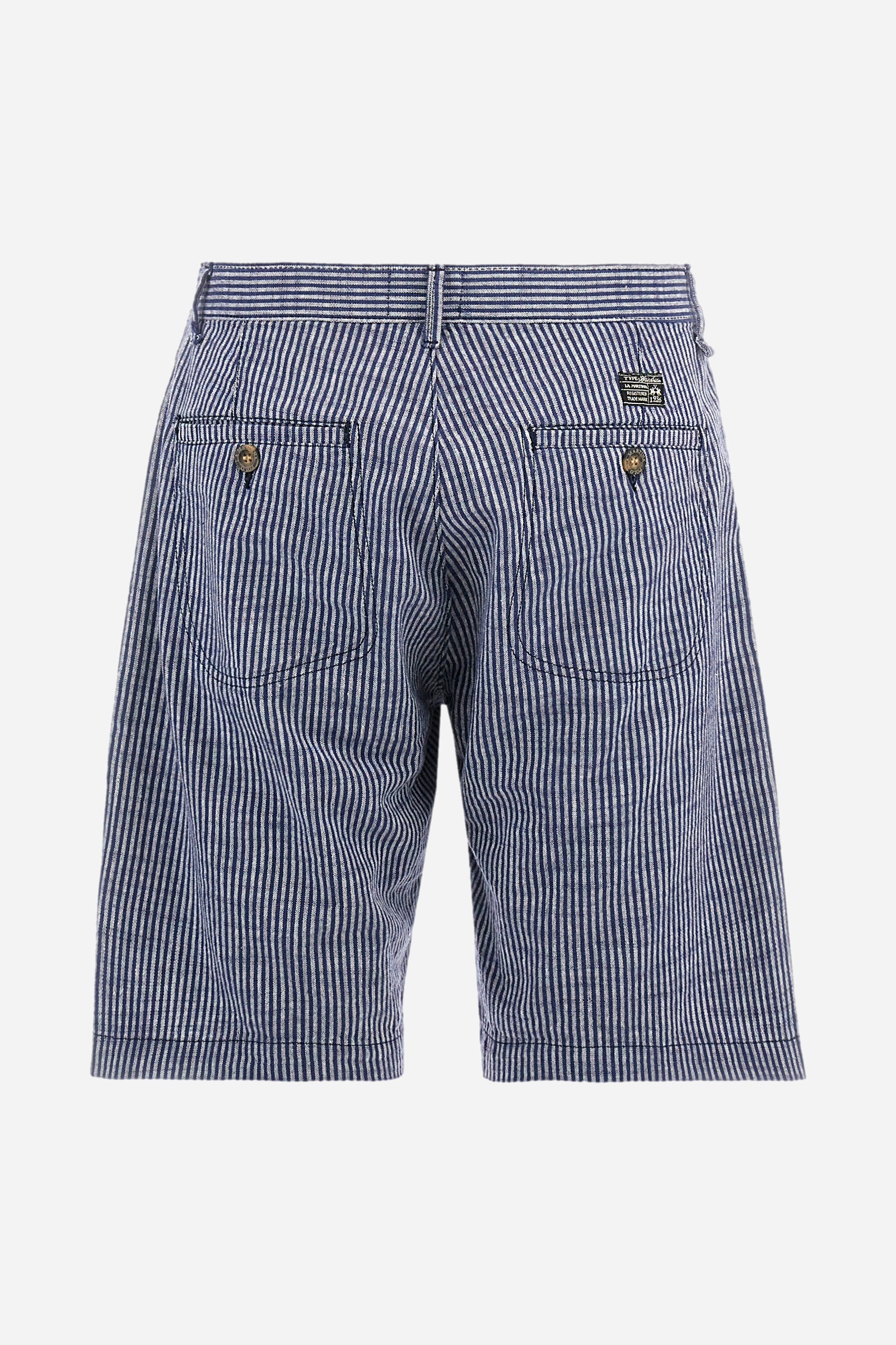 Striped men's Bermuda shorts made from luxurious cotton and linen canvas. Fastened with a zip and faux horn button. The side pockets are slanted, while the double welt back pockets are feature visible faux horn buttons and double-needle stitching around the edges. Above the right back pocket, a woven label explains the brand's quality certification. On the right hem, a graphic reading La Martina is embroidered in colourful thread. Regular fit. The model is wearing a size L. - EnsignBlue/Opt.White