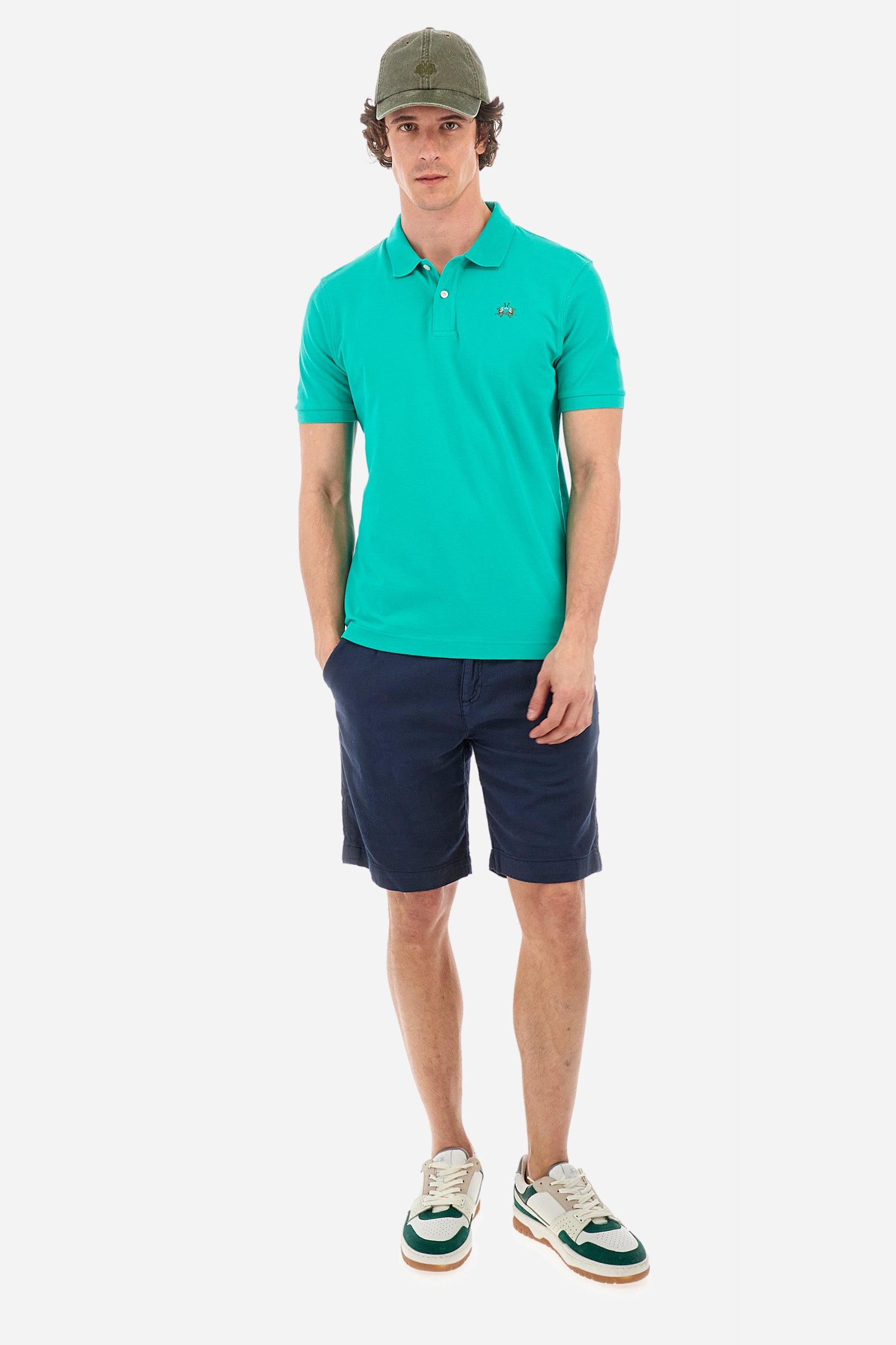 Men's single-colour short-sleeved polo in elasticated cotton. Two-button fastening. Tone-on-tone stitching. Ribbed collar and armholes. The "La Martina" lettering can be found under the collar. Featuring a small logo embroidered on the chest. In a slim fit. The model wears a size L. - Vivid Green