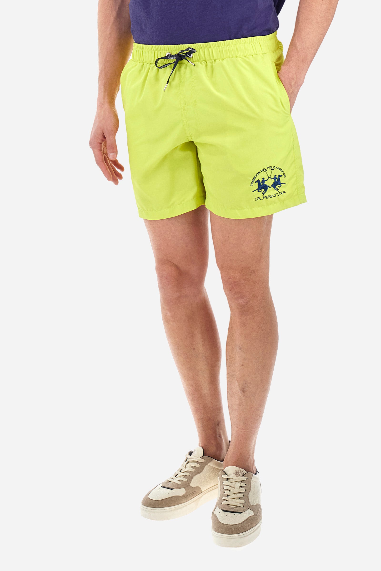 Single-colour men's swimming shorts, made of synthetic fabric. Featuring a drawstring and tie with "La Martina" lettering. Double welt pocket on the front. Closed pocket on the back. Mesh lining. Large logo embroidered on the front. The fit is regular. The model wears a size L. - Acacia