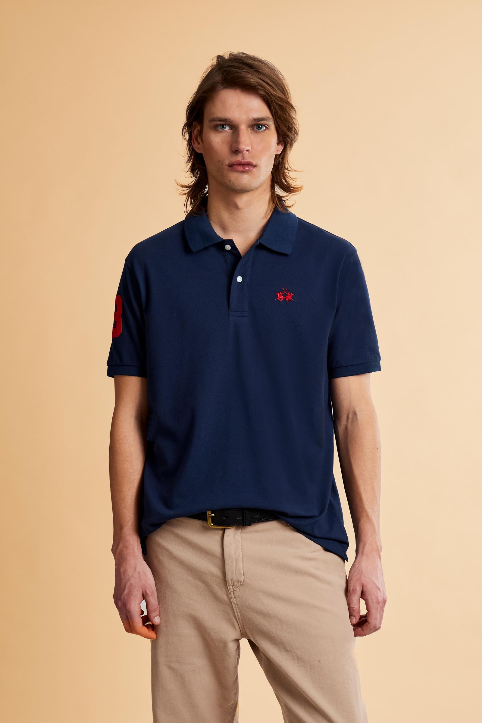 Men’s short-sleeve stretch piqué polo. Two-button placket and ribbed details, with a regular fit. Iconic style characterised by applied logo and patches. - Navy