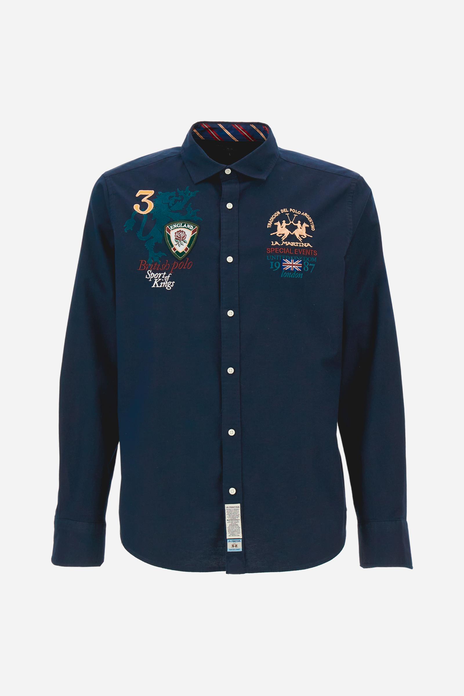 Classic men's long-sleeved shirt in stretch cotton Oxford, solid colour. Finished with a French collar and interior regimental-pattern fabric details. Chest features multicolour prints and embroideries inspired by British Polo, including the large team logo embroidered in contrast. Regular fit ensuring comfort and enhancing any physique. Model wears size L. - Navy