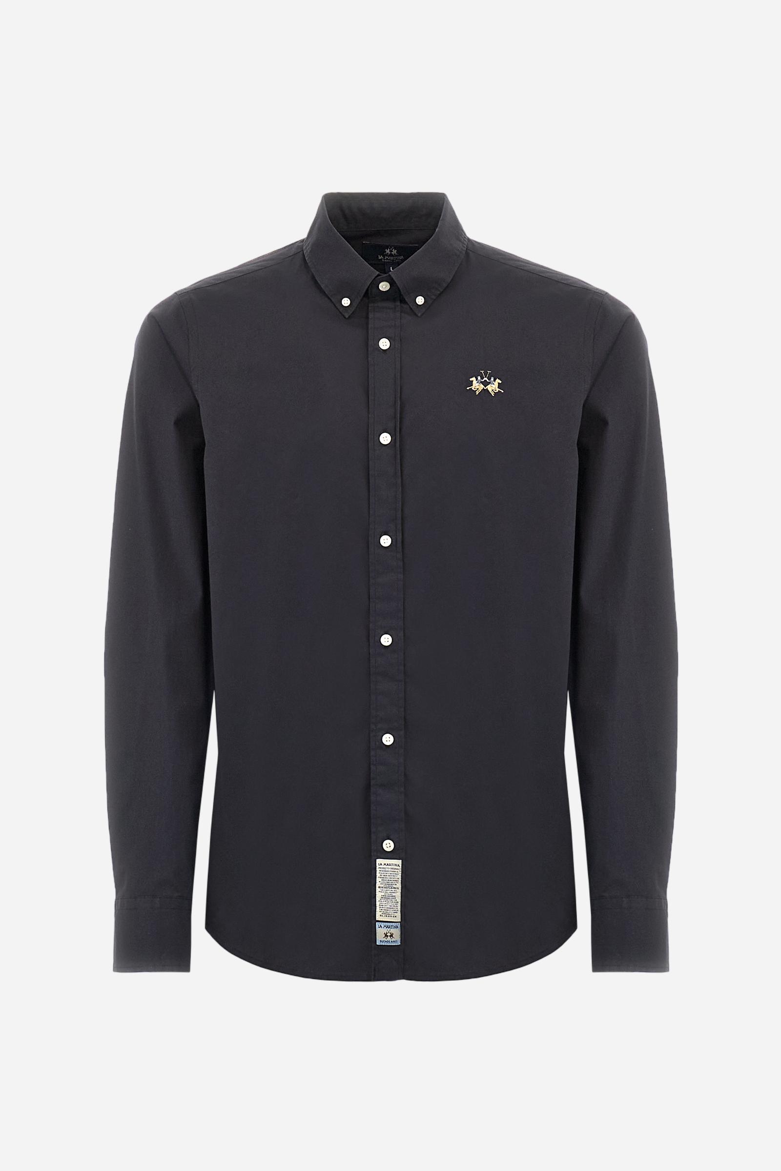 Men's plain long-sleeved shirt made from stretch cotton poplin for a comfortable fit. Featuring a button-down collar and woven labels at the bottom of the opening. A multicoloured logo is embroidered on the chest, over the heart, in contrasting thread. The slim fit ensures a sleek and modern look. The model is wearing a size L. - Black