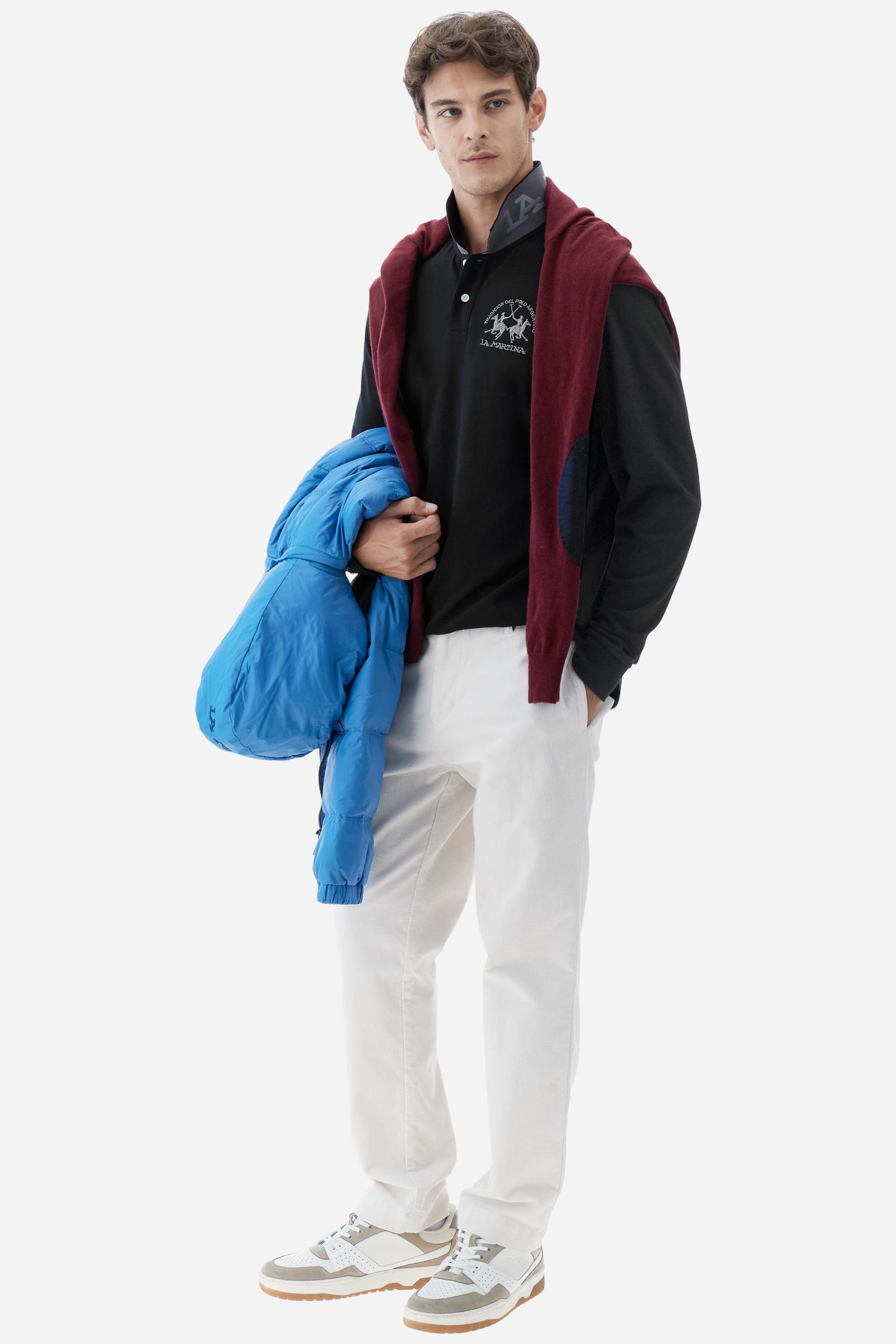 Men's long-sleeved solid colour polo shirt. Made of high-quality stretch Piqué. The collar and cuffs are in solid colour ribbing. The undercollar features a print of the iconic La Martina lettering in a contrasting colour. Featuring a logo embroidered on the chest in a contrasting colour. On the back at the bottom, the guarantee label typical of the brand's iconic models is applied. Regular fit. The model is wearing a size L. - Black