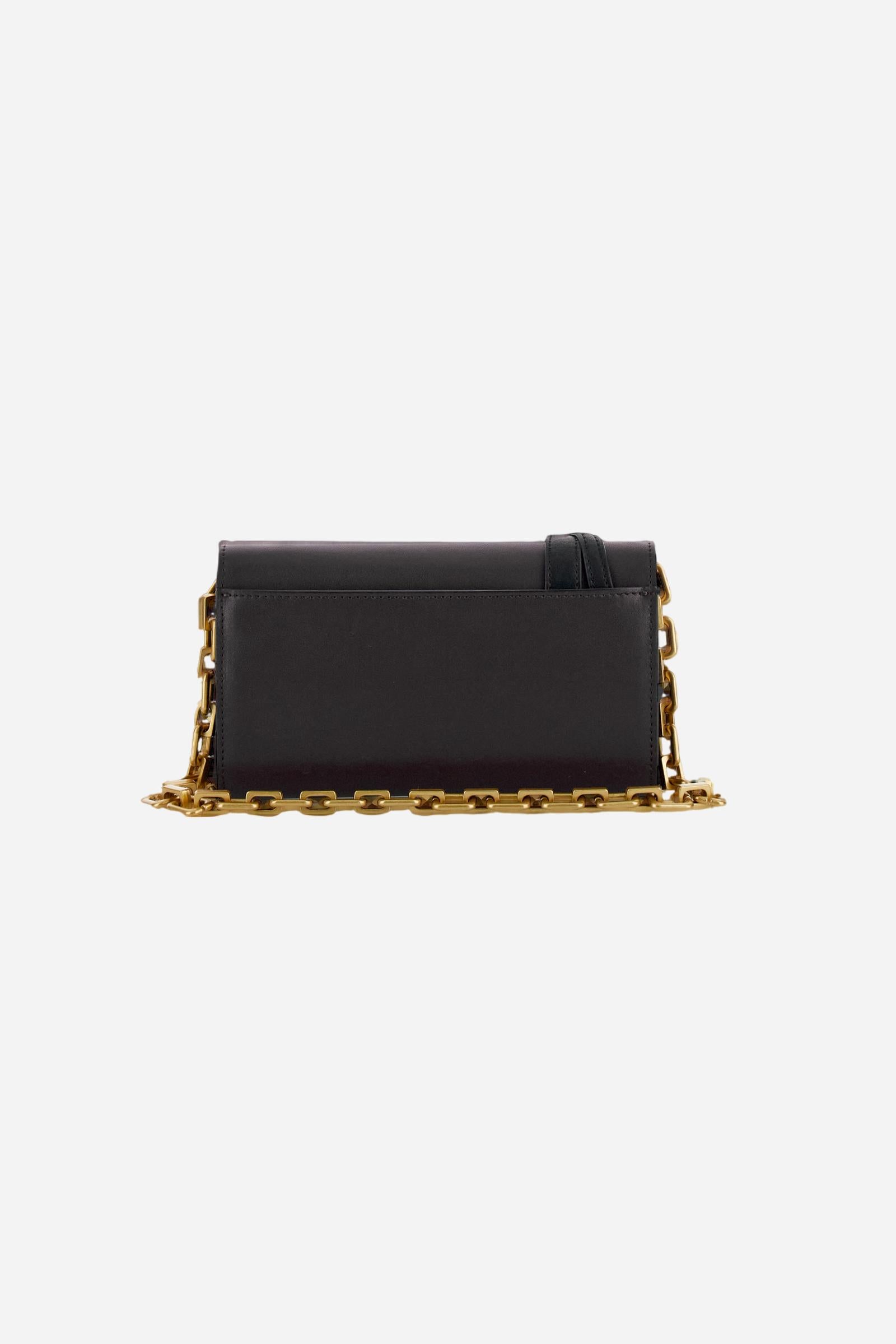 Leather chain wallet in soft calfskin with shaped flap and contrasting leather details. Decorated with a small golden buckle and engraved logo. - Black