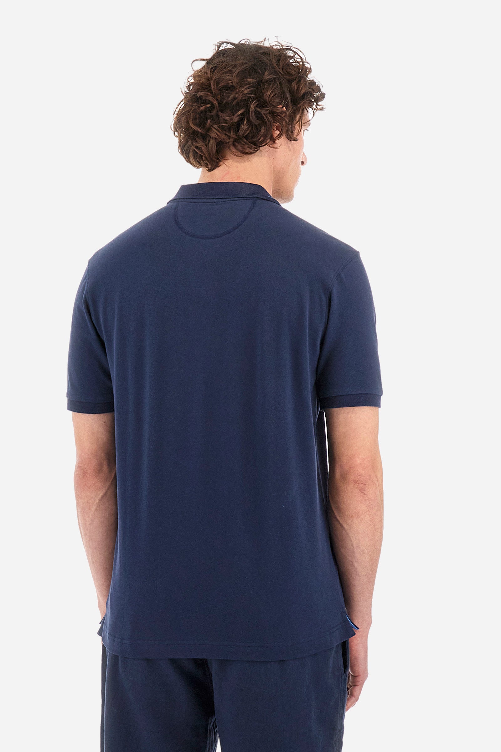 Men's single-colour short-sleeved polo in elasticated cotton. Two-button fastening. Ribbed collar and armholes with a stripe in different shades. Featuring a small logo embroidered on the chest. The fit is regular. The model wears a size L. - Navy