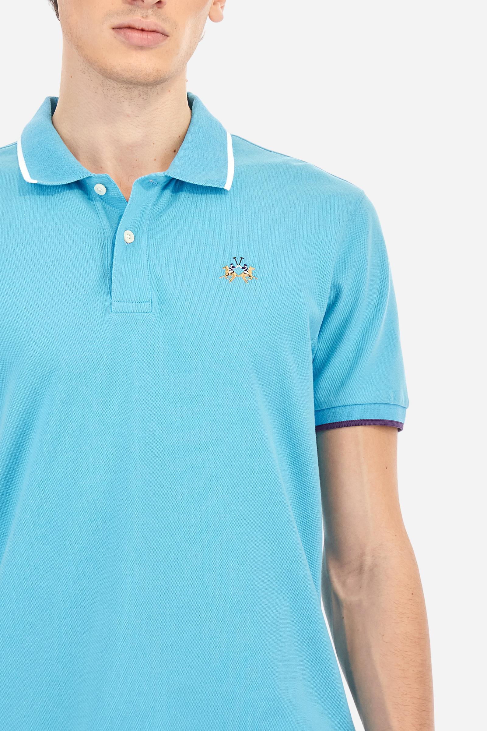 Short-sleeved, single-colour men's polo shirt made of stretch cotton piqué. Fastens with two buttons. The collar and cuffs are ribbed, and there is a colour-contrasting trim at the bottom of the collar. Inside the collar there is a grosgrain ribbon of a different shade. The logo is embroidered on the chest in a contrasting colour. The fit is slim. The model is wearing a size L. - Blue Mist