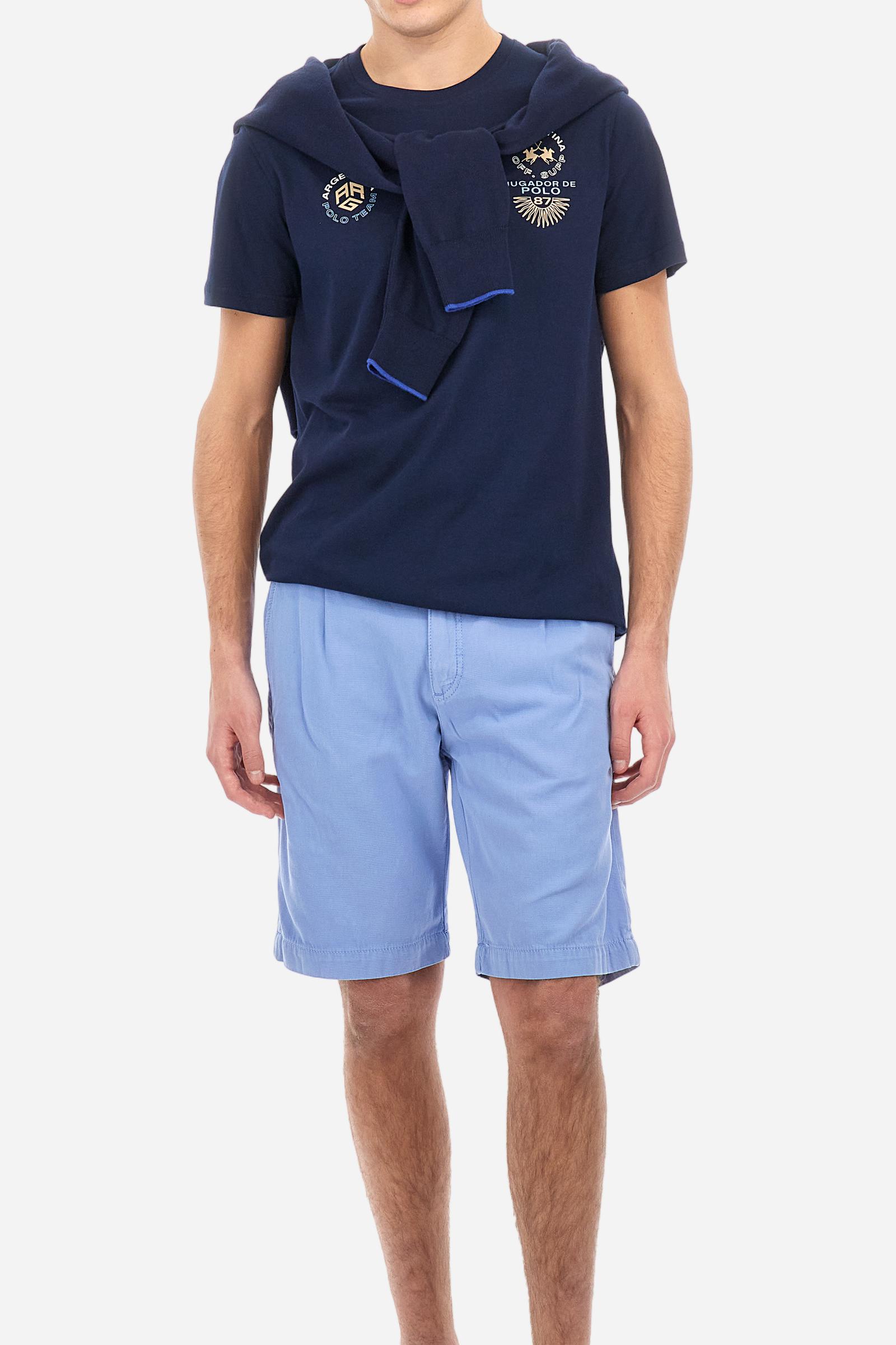 Men's plain cotton jersey T-shirt. Crew-neck model with matching ribbed collar. A contrasting jersey ribbon is applied on the inside of the collar. On the chest we find two graphics, both printed with contrasting colours and gold, that make references to Argentina. On the right sleeve the number 3 is present as a two-tone print with a slightly rubberised appearance. The logo and the La Martina lettering are printed on the chest, left side. Regular fit. The model is wearing a size L. - Navy