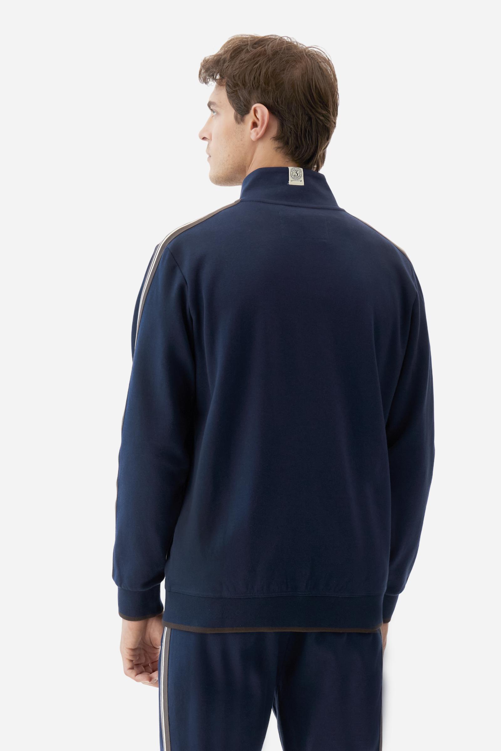 Men's long-sleeved, full-zip sweatshirt. Made of soft solid colour cotton fleece. The neck and cuffs and waistband are in solid colour ribbed knit with contrasting edging. Front zip opening and Polo club guarantee label applied to the edge inside the collar. The front lettering is a large tone-on-tone raised embroidery. A narrow two-tone striped band is applied to the shoulders and sleeves. Regular fit. The model is wearing a size L. - Navy