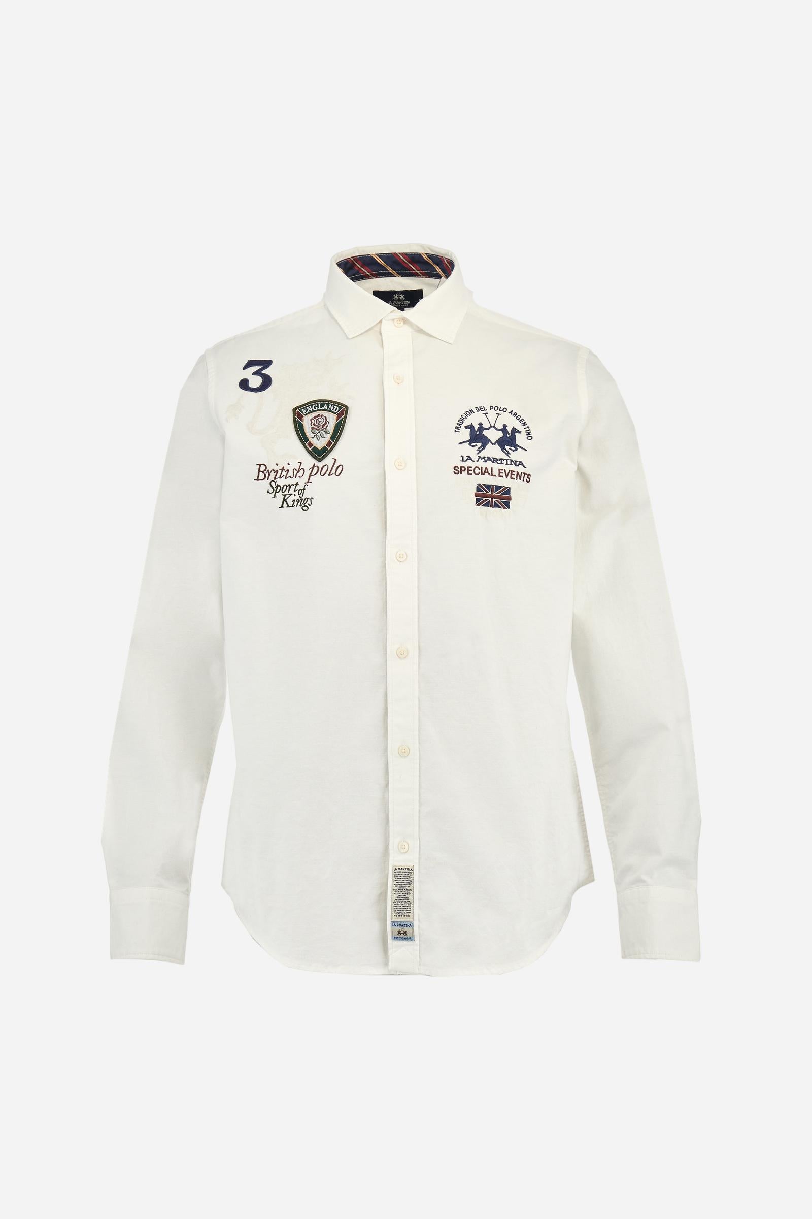 Classic men's long-sleeved shirt in stretch cotton Oxford, solid colour. Finished with a French collar and interior regimental-pattern fabric details. Chest features multicolour prints and embroideries inspired by British Polo, including the large team logo embroidered in contrast. Regular fit ensuring comfort and enhancing any physique. Model wears size L. - Optic White