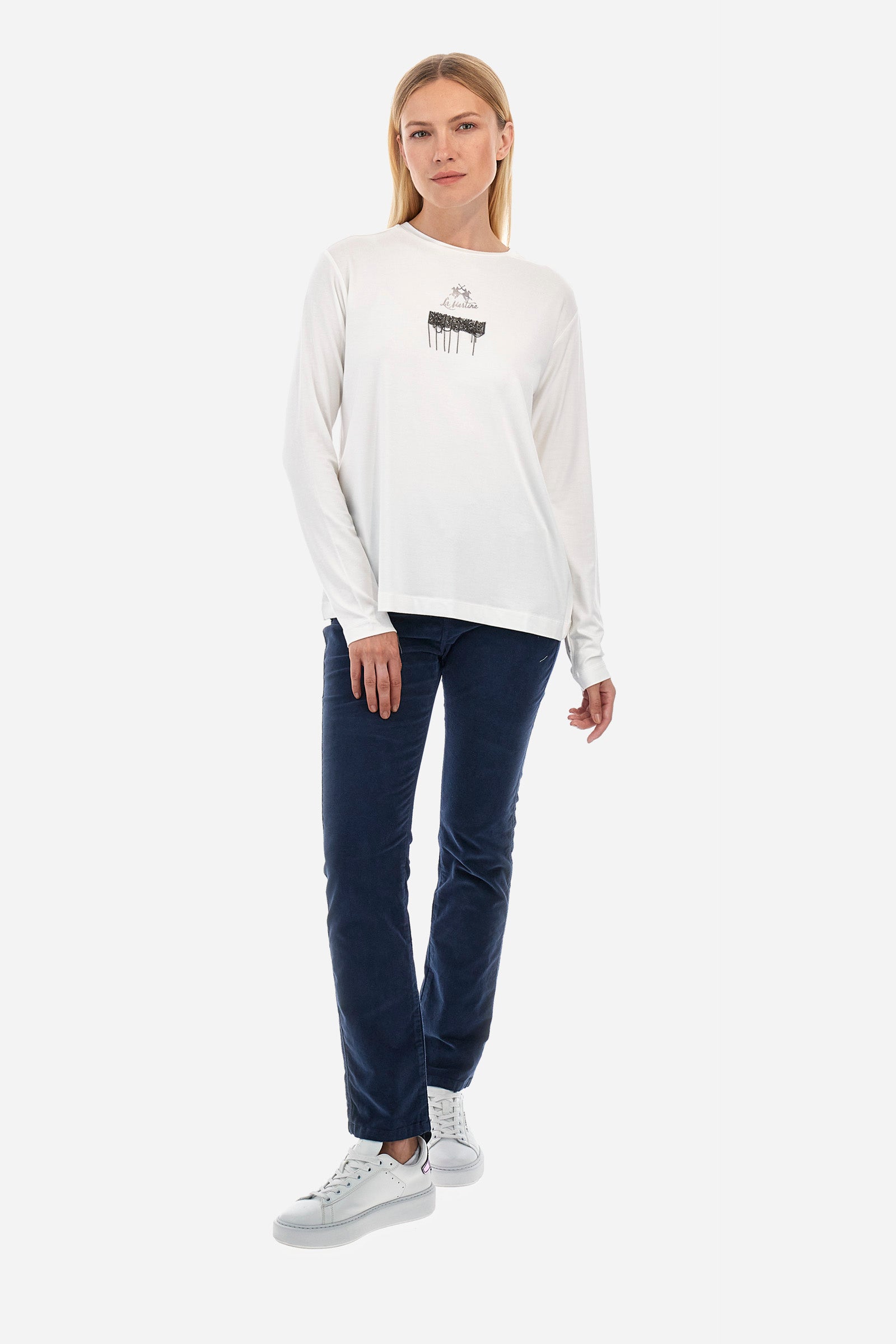 This long-sleeved women's T-shirt is made of stretch viscose for optimal comfort. The regular fit is perfect for any occasion. It features a basic solid colour suitable for any outfit. The crew-neck is enriched with a logo and a jewel detail for a touch of elegance. A versatile and quality garment for every woman's wardrobe. The model is 174 cm tall and wears a size 2. - Off White