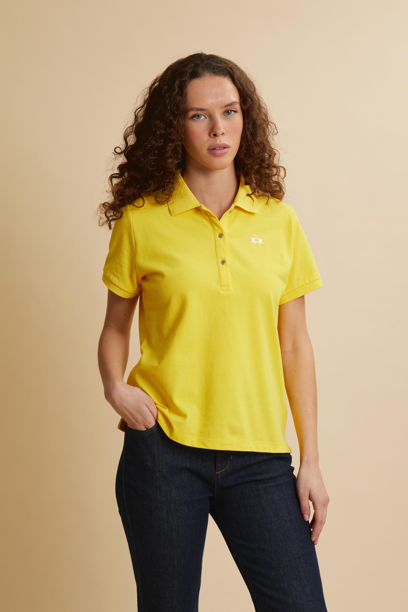 Women’s short-sleeve polo in stretch piqué. Updated regular fit for a more contemporary silhouette. Ribbed collar and cuffs in matching tone, small placket with custom buttons. Brand lettering printed in contrast under the collar and small embroidered logo on the chest. The model wears size 2. - Empire Yellow