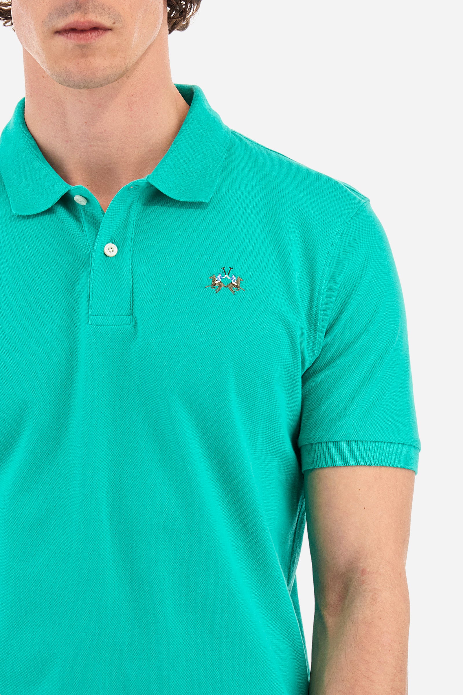 Men's single-colour short-sleeved polo in elasticated cotton. Two-button fastening. Tone-on-tone stitching. Ribbed collar and armholes. The "La Martina" lettering can be found under the collar. Featuring a small logo embroidered on the chest. In a slim fit. The model wears a size L. - Vivid Green