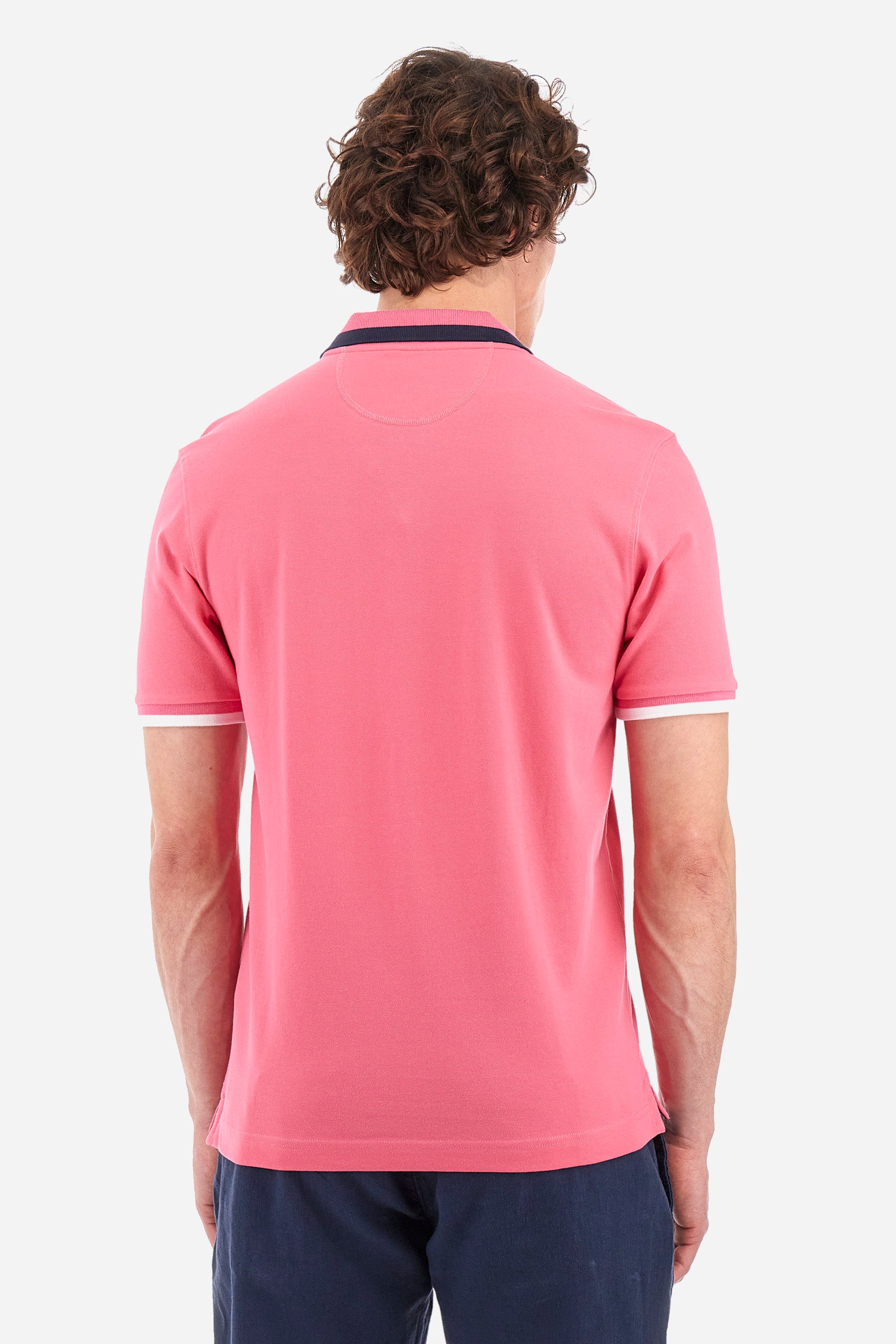 Men's single-colour short-sleeved polo in elasticated cotton. Two-button fastening. Ribbed collar and armholes with a stripe in different shades. The "La Martina" lettering can be found under the collar. Featuring a small logo embroidered on the chest. In a slim fit. The model wears a size L. - Hot Pink
