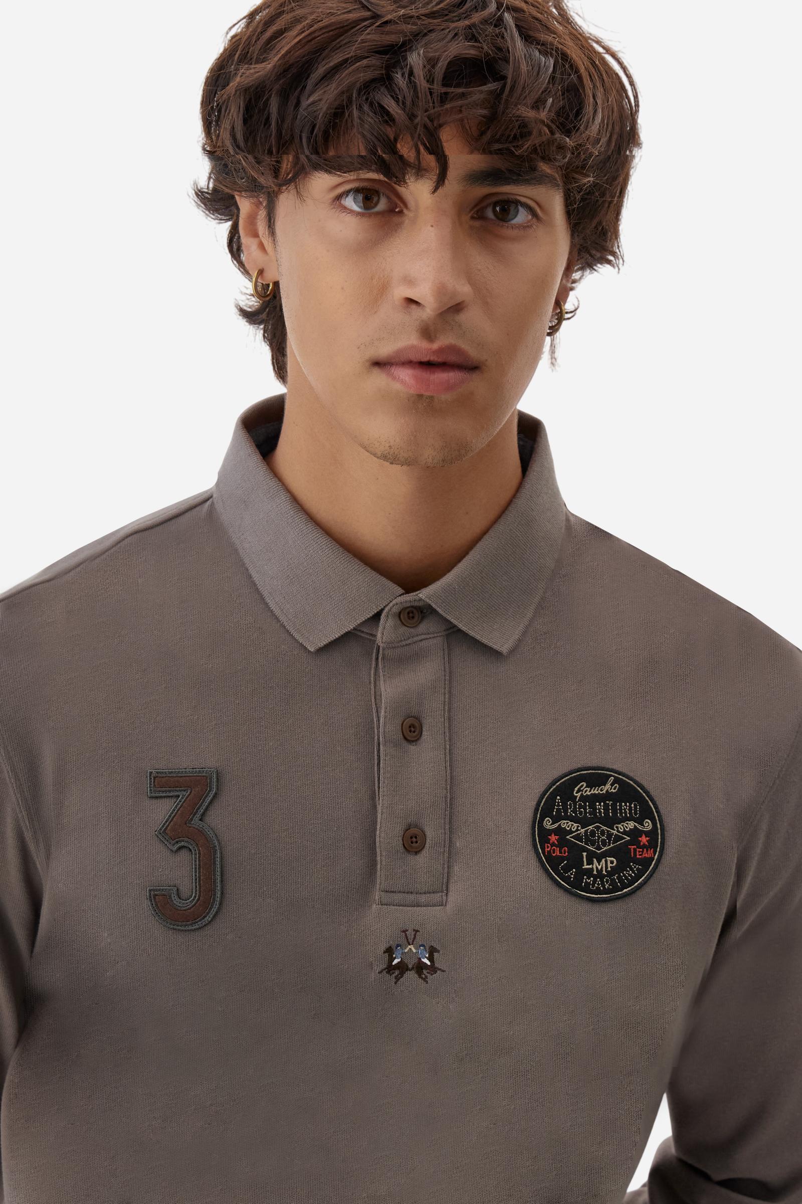 Long-sleeve polo shirt crafted from 100% high-quality cotton jersey. The velvety fabric offers a warm, cozy feel, perfect for cooler seasons. Ribbed collar and cuffs in matching tone, with a three-button personalized placket. A small multicolor embroidered logo sits below the opening, while tonal patches in different shapes and textures, inspired by Argentine culture and Gaucho tradition, decorate the chest and back. Classic regular fit. Model wears size L. - Falcon