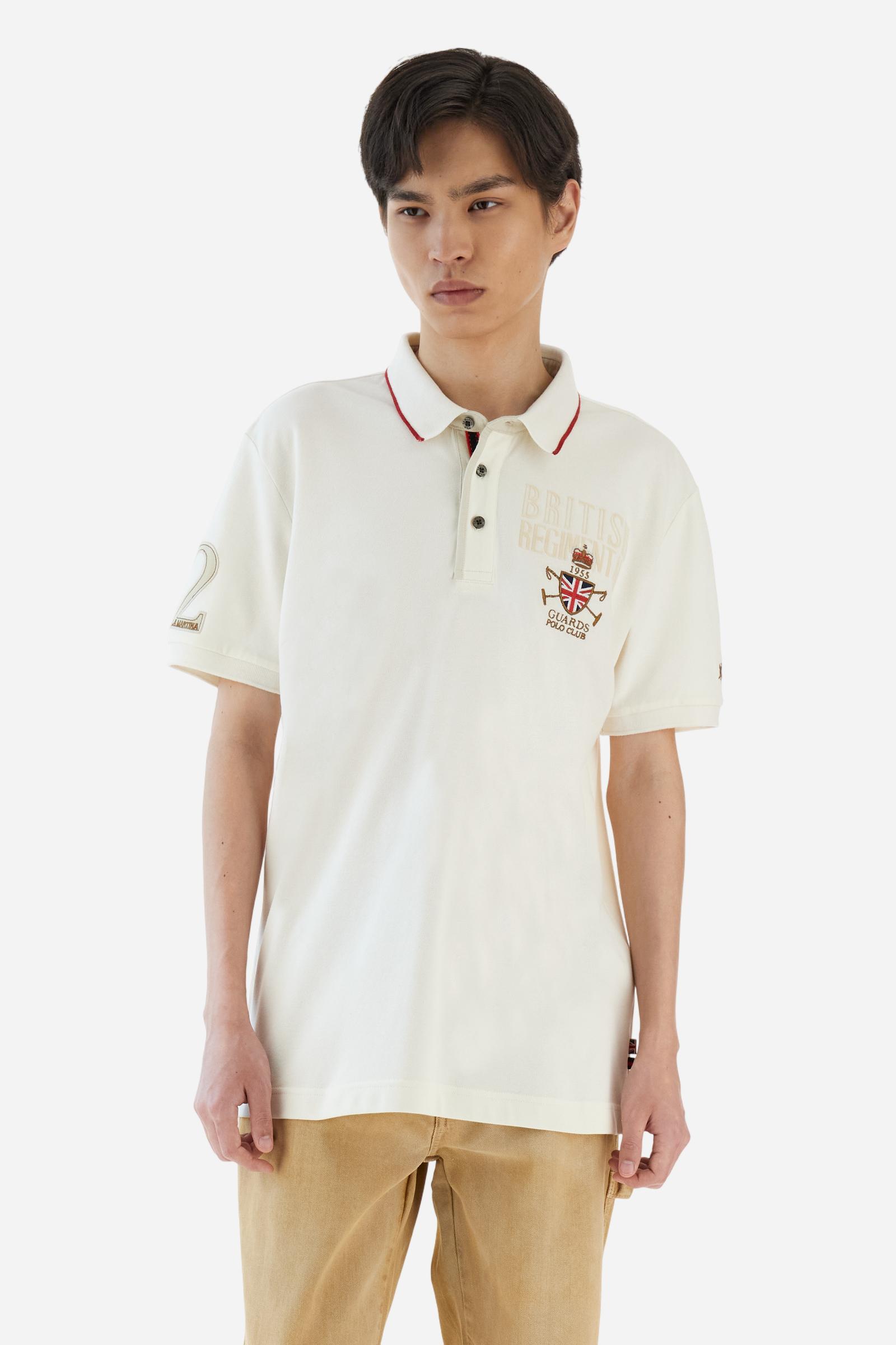 Short-sleeve polo shirt from the Guards capsule, made of high-quality stretch cotton piqué. Ribbed collar and cuffs in matching tone, with contrast striped detail on the collar. Three-button personalized placket. Multicolor graphics, patches, and lettering celebrate the British regiment, applied to chest and sleeves. Brand logo embroidered in contrast on the left sleeve. Regular straight fit. Model wears size L. - Pristine