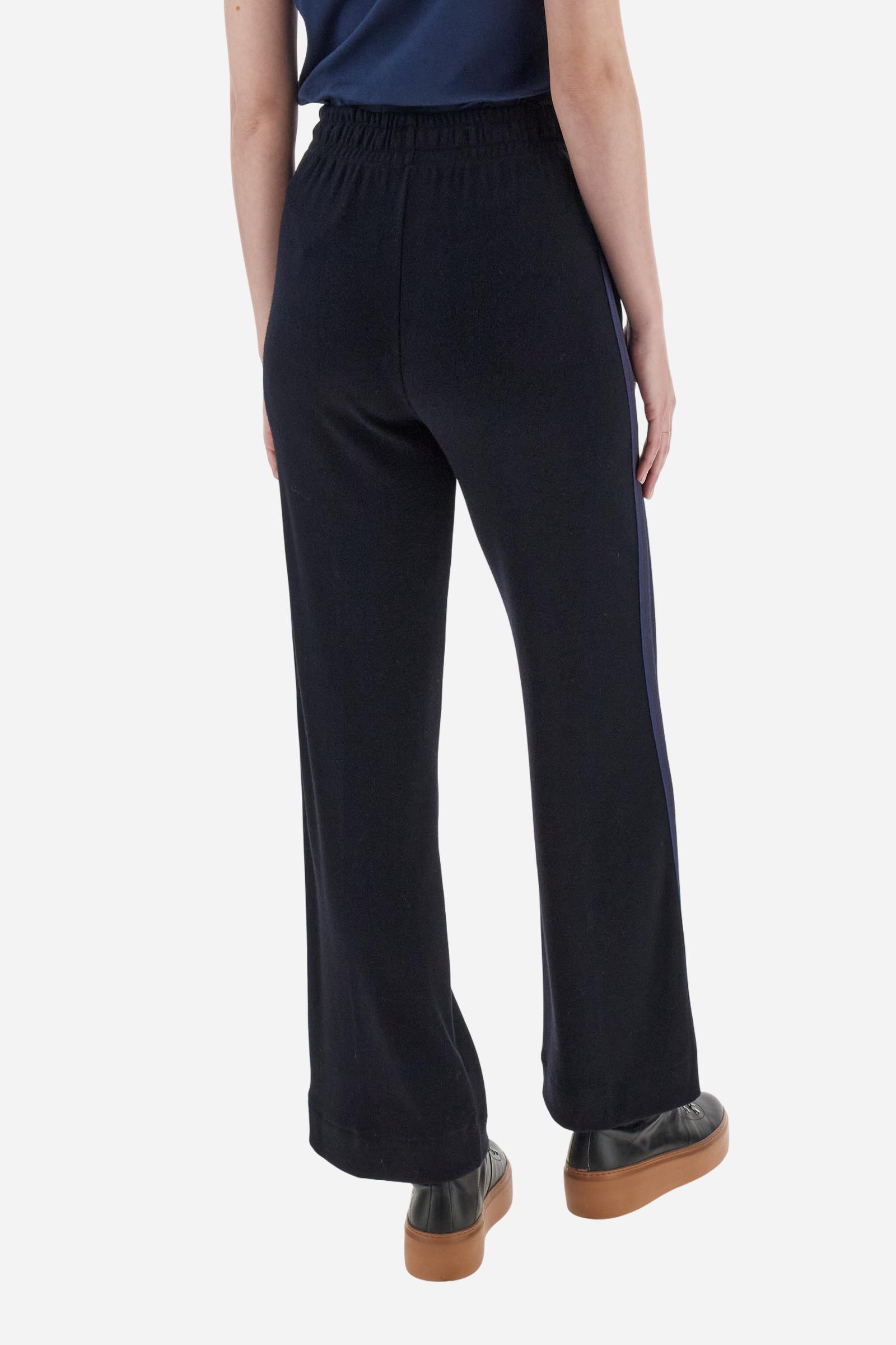Women’s pants made of viscose-blend interlock fleece, soft and luxurious on the skin. Elastic waistband with adjustable drawstring ensures optimal comfort. Side pockets and bicolor striped tape along the sides complete the design. A small tonal embroidered logo enriches the front. Straight leg with slightly flared hem for a feminine, elegant twist in athleisure style. Model wears size 2. - Navy