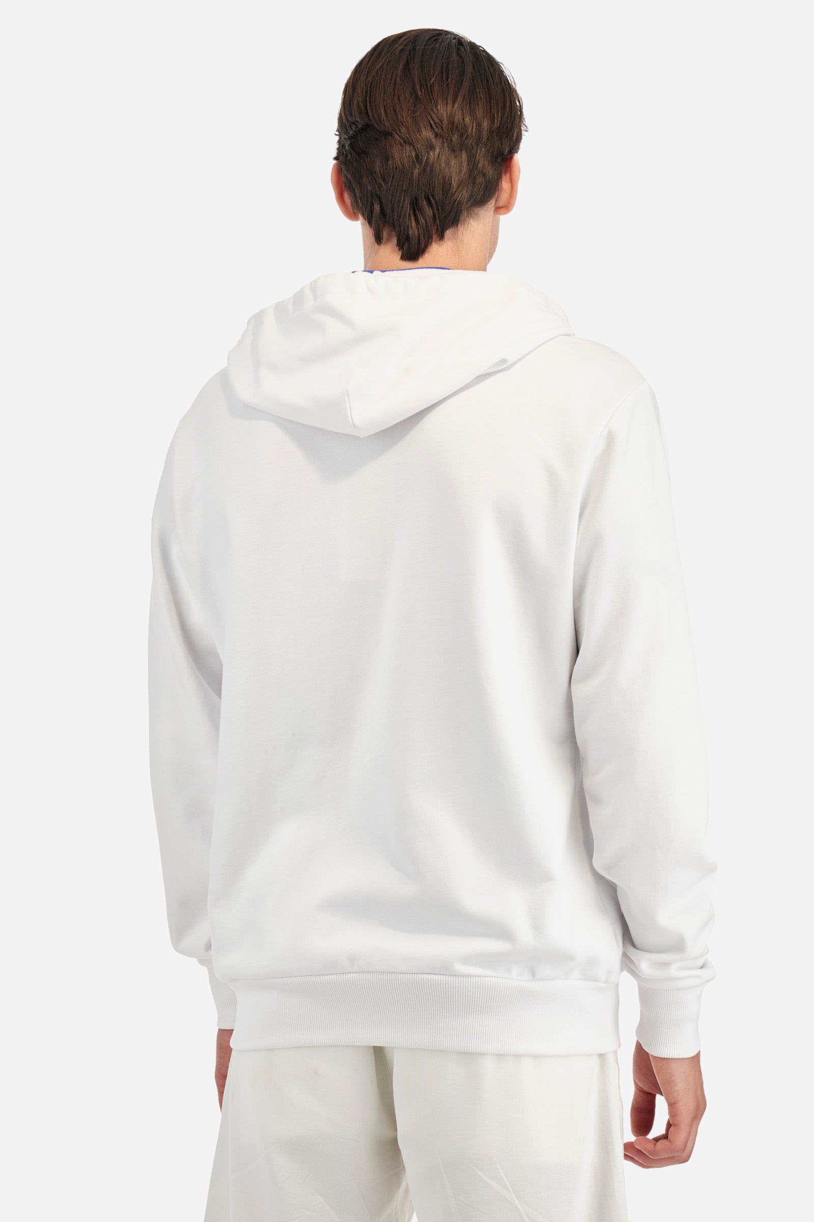 Men's long-sleeved plain sweatshirt made from French terry cotton. Full-zip fastening and hood with adjustable drawstring. On the chest, the La Martina Polo lettering is present as a large, slightly embossed embroidery, while the number 3 is present as a patch made of the same fabric and applied with an embroidered cord in a contrasting colour. The logo is embroidered on the chest, left side. Regular fit. The model is wearing a size L. - OptWhite/Surf TheWeb