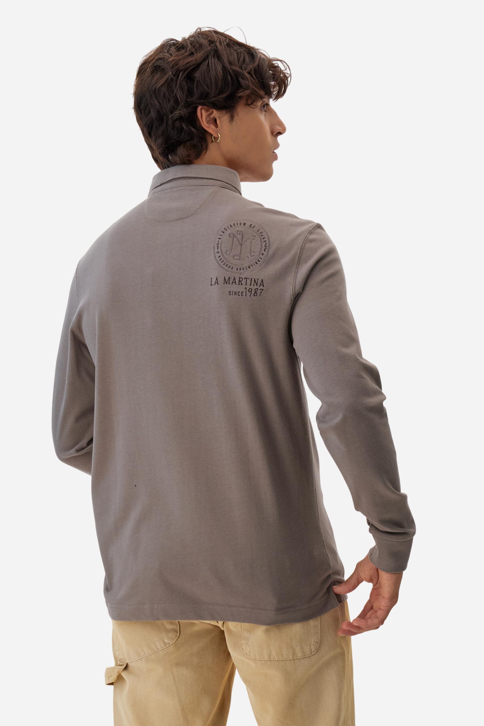 Long-sleeve polo shirt crafted from 100% high-quality cotton jersey. The velvety fabric offers a warm, cozy feel, perfect for cooler seasons. Ribbed collar and cuffs in matching tone, with a three-button personalized placket. A small multicolor embroidered logo sits below the opening, while tonal patches in different shapes and textures, inspired by Argentine culture and Gaucho tradition, decorate the chest and back. Classic regular fit. Model wears size L. - Falcon