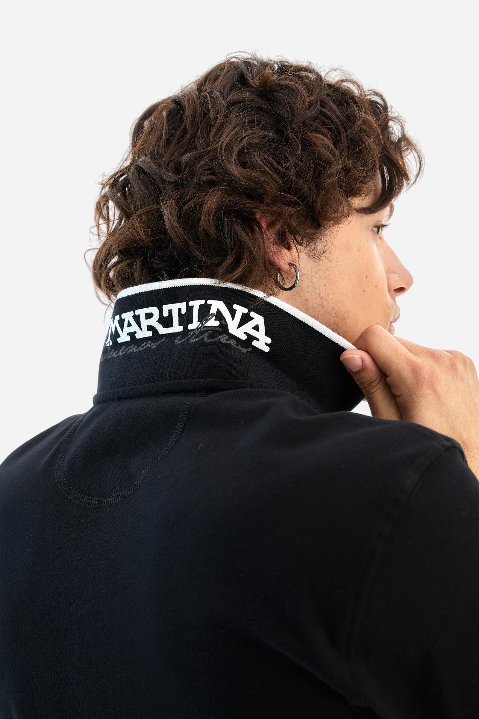 Short-sleeved, single-colour men's polo shirt made of stretch cotton piqué. Fastens with two buttons. The collar and cuffs are ribbed, and there is a colour-contrasting trim at the bottom of the collar. Inside the collar there is a grosgrain ribbon of a different shade. The logo is embroidered on the chest in a contrasting colour. The fit is slim. The model is wearing a size L. - Black