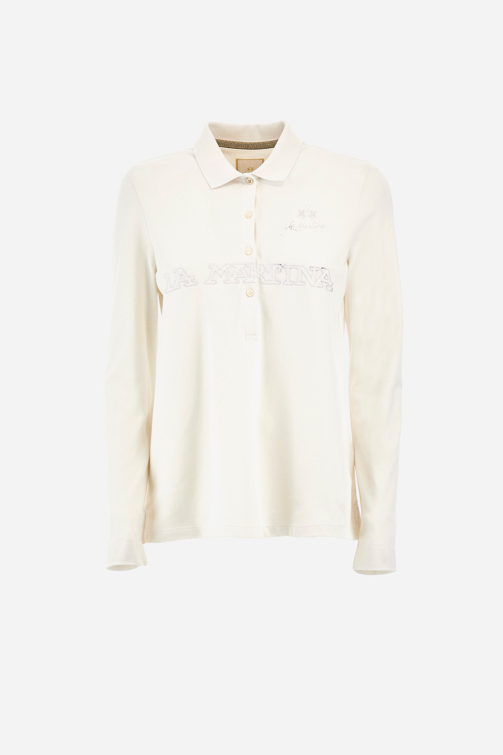 This women's polo shirt from the Timeless line is made of stretch cotton and has a regular fit. Available in a wide range of colours, it is perfect for those looking for a simple but quality garment. The solid colour and the embossed print of the La Martina logo on the front, together with the number 3, make it an elegant and unique garment. The classic 4-button collar completes the ideal look for a casual or sporty outfit. The model is 174 cm tall and wears a size 2. - Blanc de Blanc