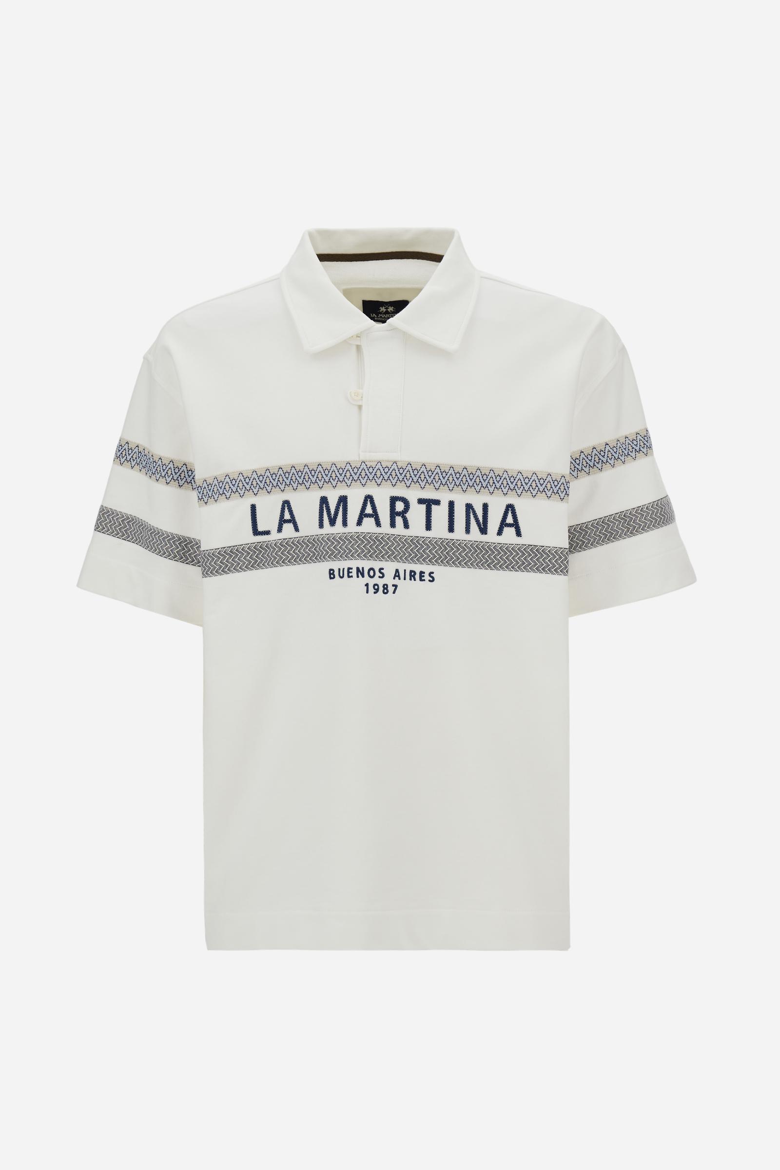 Short-sleeve polo in heavy cotton jersey with a compact structure and substantial hand feel. Contemporary fit with relaxed volume and slightly dropped shoulders. Classic collar with visible placket and bold horizontal band with geometric multicolor tapes. Raised “La Martina” embroidery on the chest and contrasting 3D logo on the back. - Off White