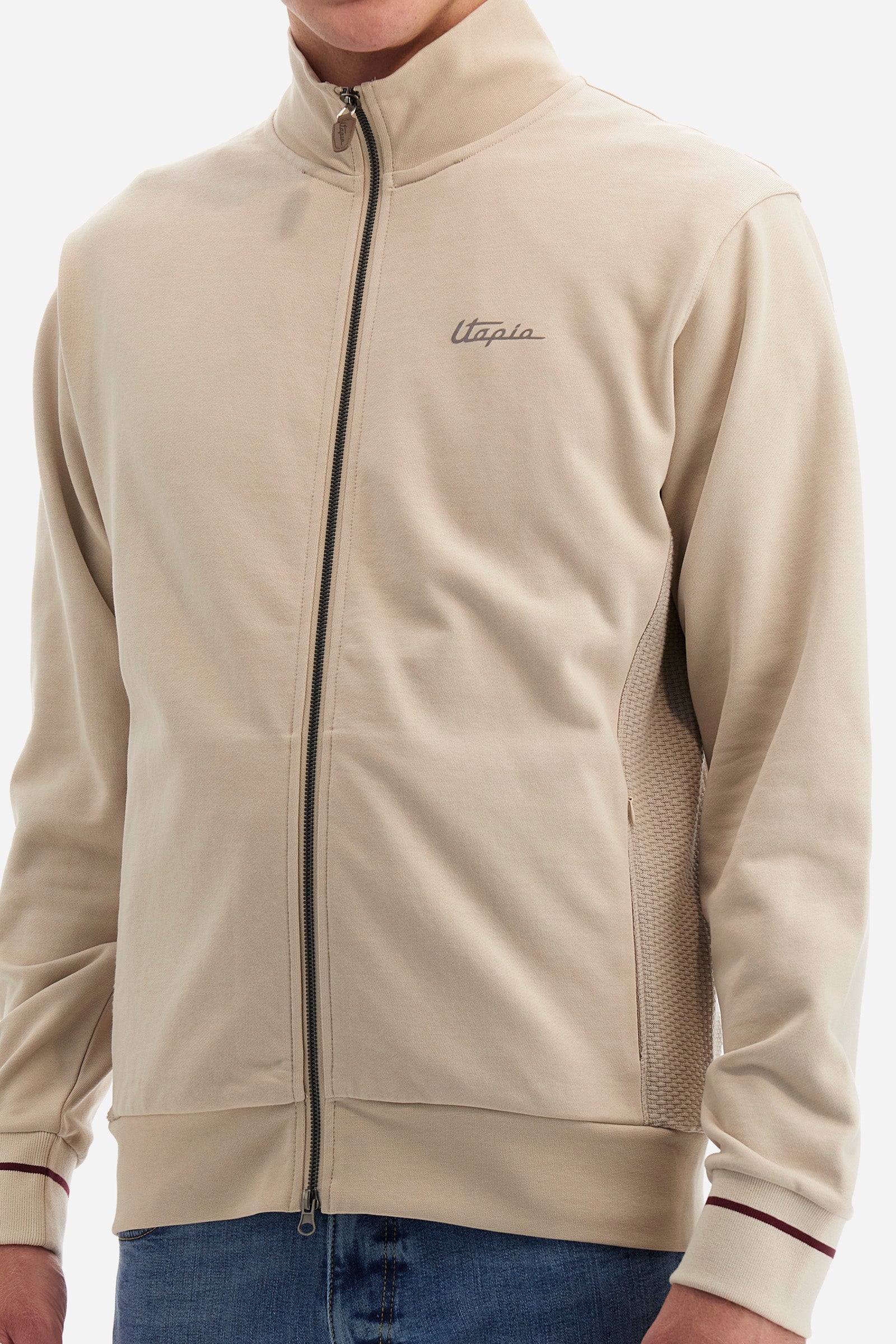Single-colour long-sleeved men's sweatshirt with full zip fastening from the line in collaboration with Pagani. Made of 100% cotton. Mock neck, ribbed waistband and cuffs. Double back pocket. On the sides the garment has a different texture from the main part. There is lettering on the front, while a plate featuring the La Martina logo and the Pagani logo is sewn on the back. The fit is regular. The model wears a size L. - Rainy Day
