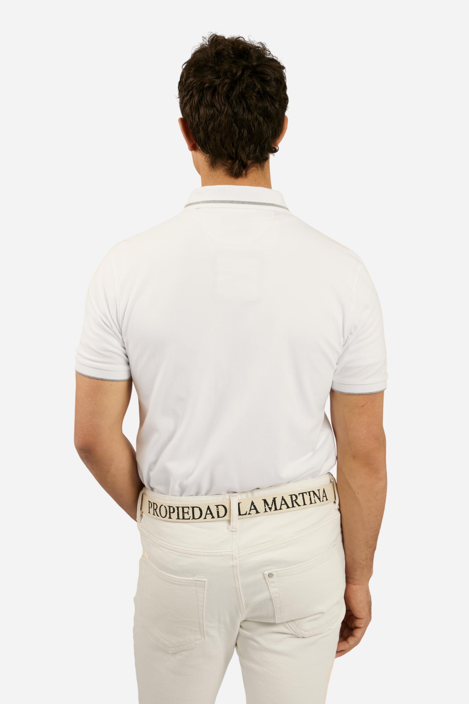 Men's plain short-sleeved polo shirt made from stretch piqué. Two-button fastening. The collar and cuffs are made from ribbed fabric with narrow contrasting trim at the bottom. The large La Martina Polo lettering on the chest is embroidered in contrasting thread. The number 3 patch appliquéd on the right side of the chest and the logo on the left side are also embroidered using contrasting thread. Regular fit. The model is wearing a size L. - Optic White
