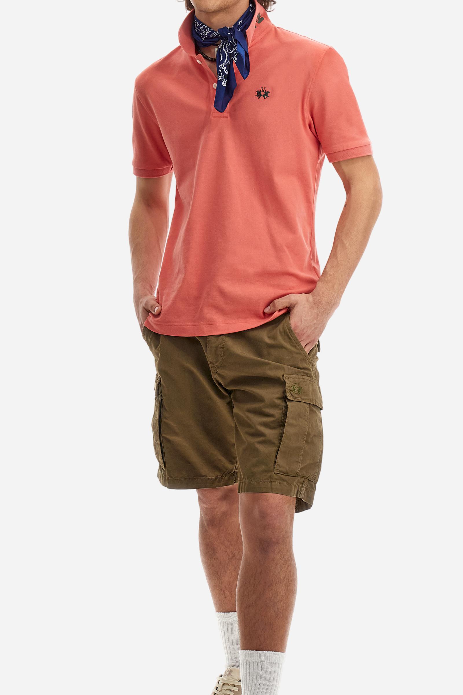 Men's plain short-sleeved polo shirt made from stretch piqué. Two-button fastening. The collar and cuffs are made from tone-on-tone ribbed fabric. A contrasting fabric patch depicting the number 3 is appliquéd on the right sleeve. The logo is embroidered on the left side of the chest in contrasting thread. Under the collar, there is a large contrasting print of the La Martina lettering. Regular fit. The model is wearing a size L. - Acai