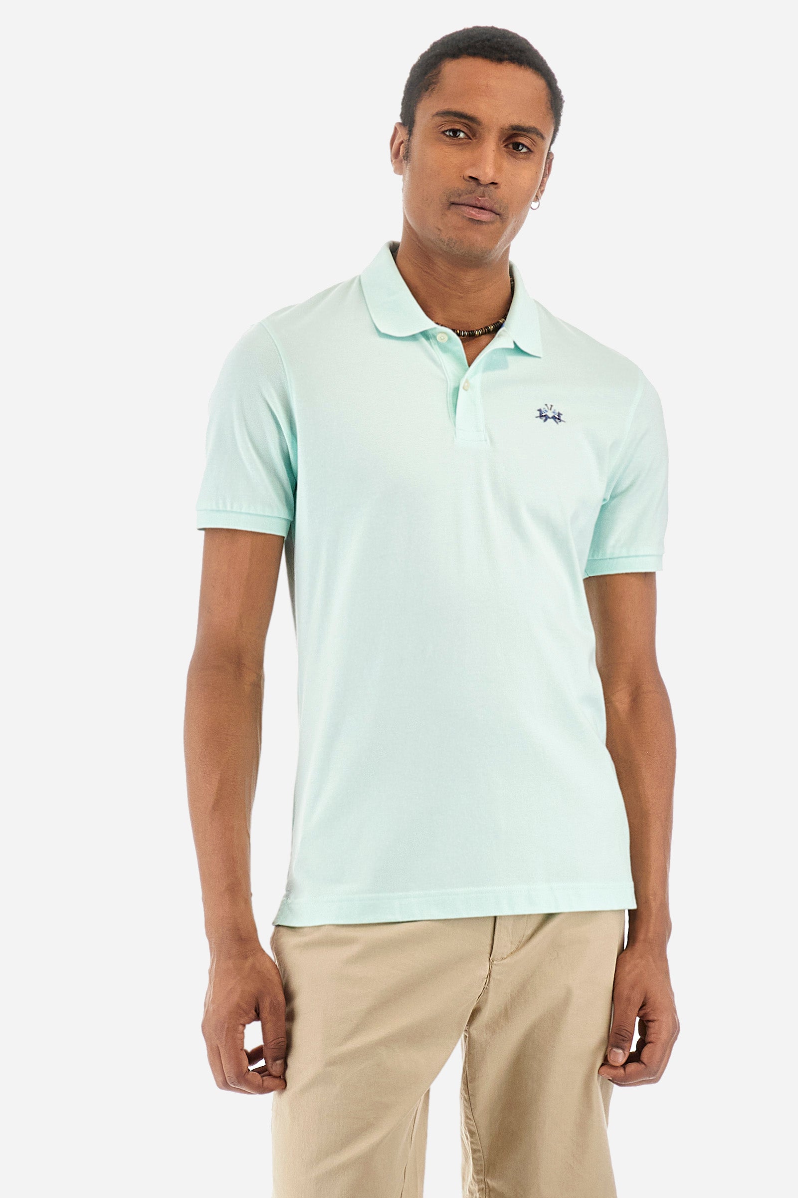 Men's single-colour short-sleeved polo in elasticated cotton. Two-button fastening. Tone-on-tone stitching. Ribbed collar and armholes. The "La Martina" lettering can be found under the collar. Featuring a small logo embroidered on the chest. In a slim fit. The model wears a size L. - Honeydew