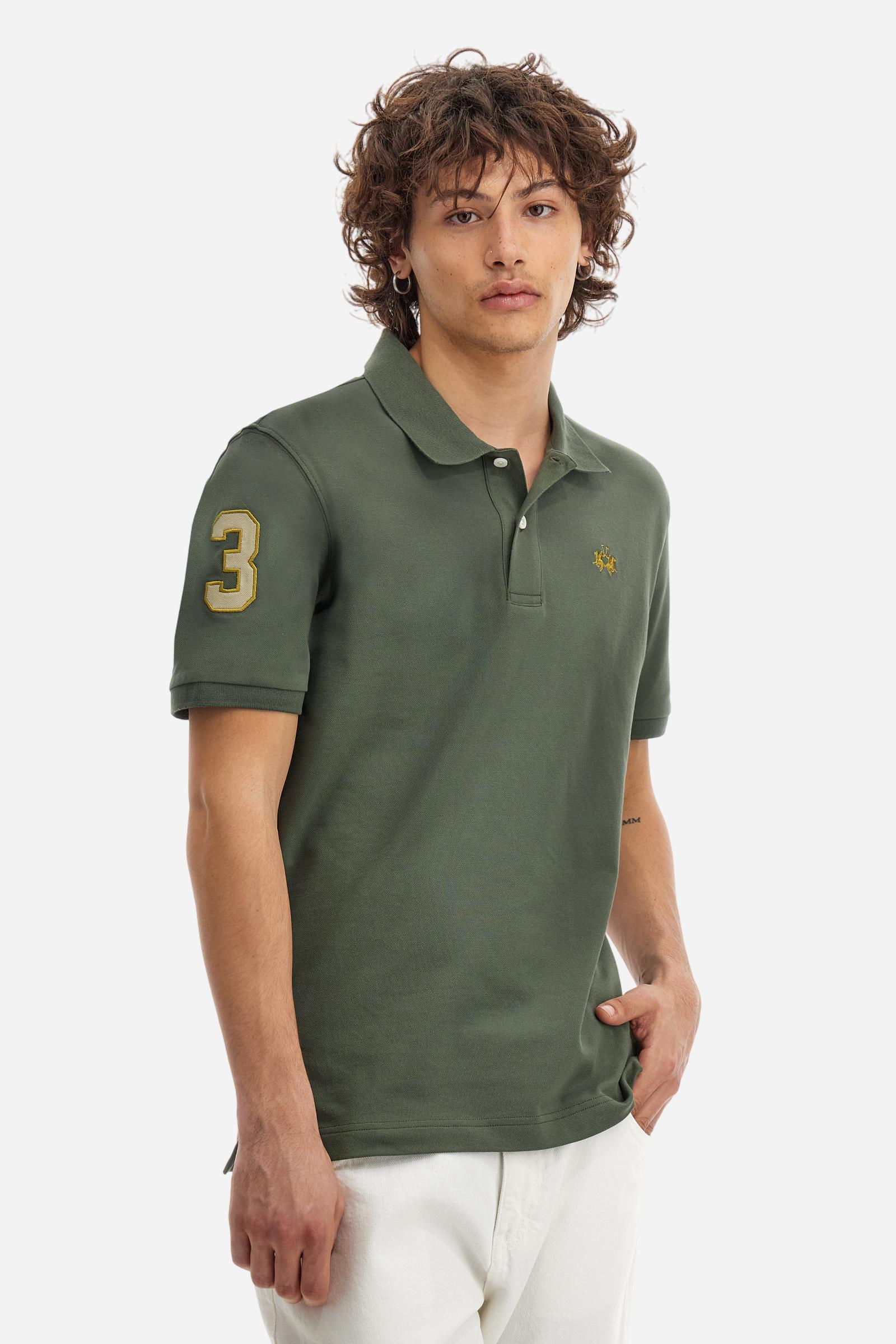 Men's plain short-sleeved polo shirt made from stretch piqué. Two-button fastening. The collar and cuffs are made from tone-on-tone ribbed fabric. A contrasting fabric patch depicting the number 3 is appliquéd on the right sleeve. The logo is embroidered on the left side of the chest in contrasting thread. Under the collar, there is a large contrasting print of the La Martina lettering. Regular fit. The model is wearing a size L. - Thyme