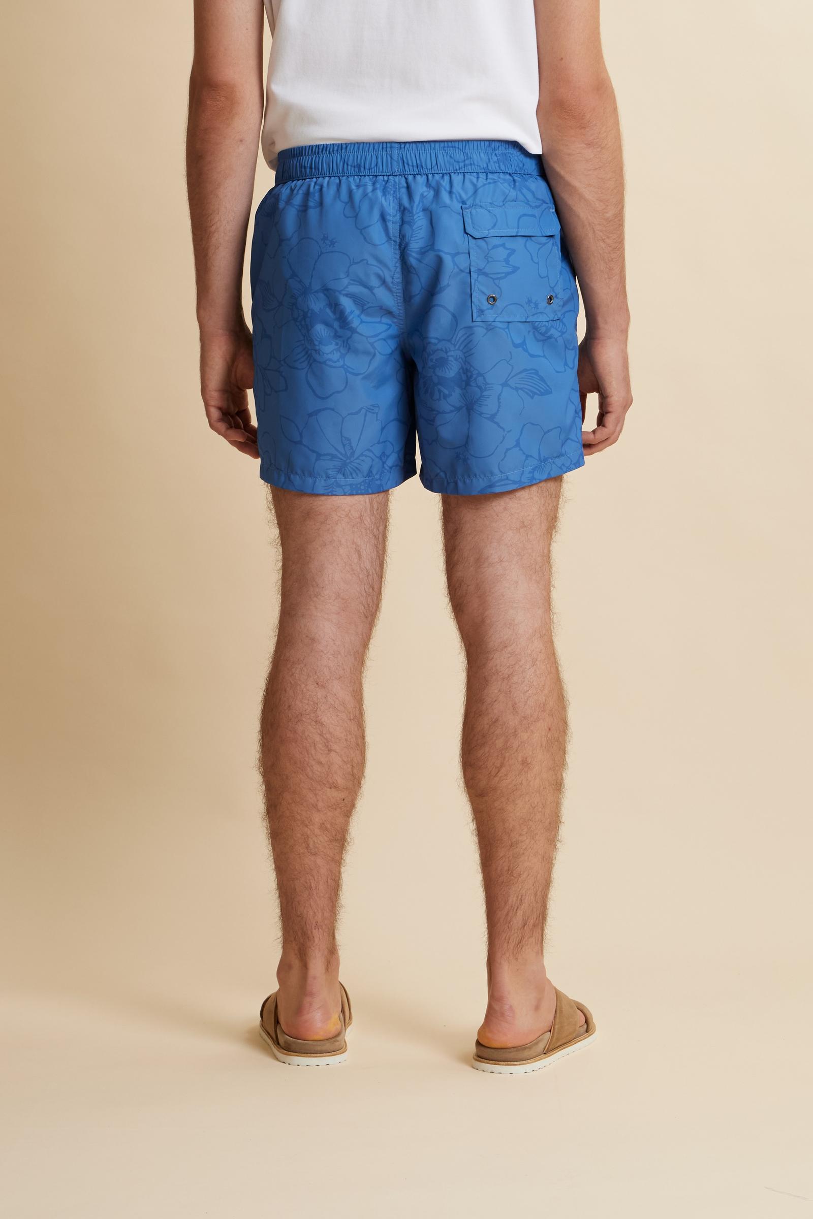 Men’s nylon swim shorts with floral print. Mid-length design with elasticated waistband, drawstring and contrasting embroidered logo. - Riviera/Dutch Blue