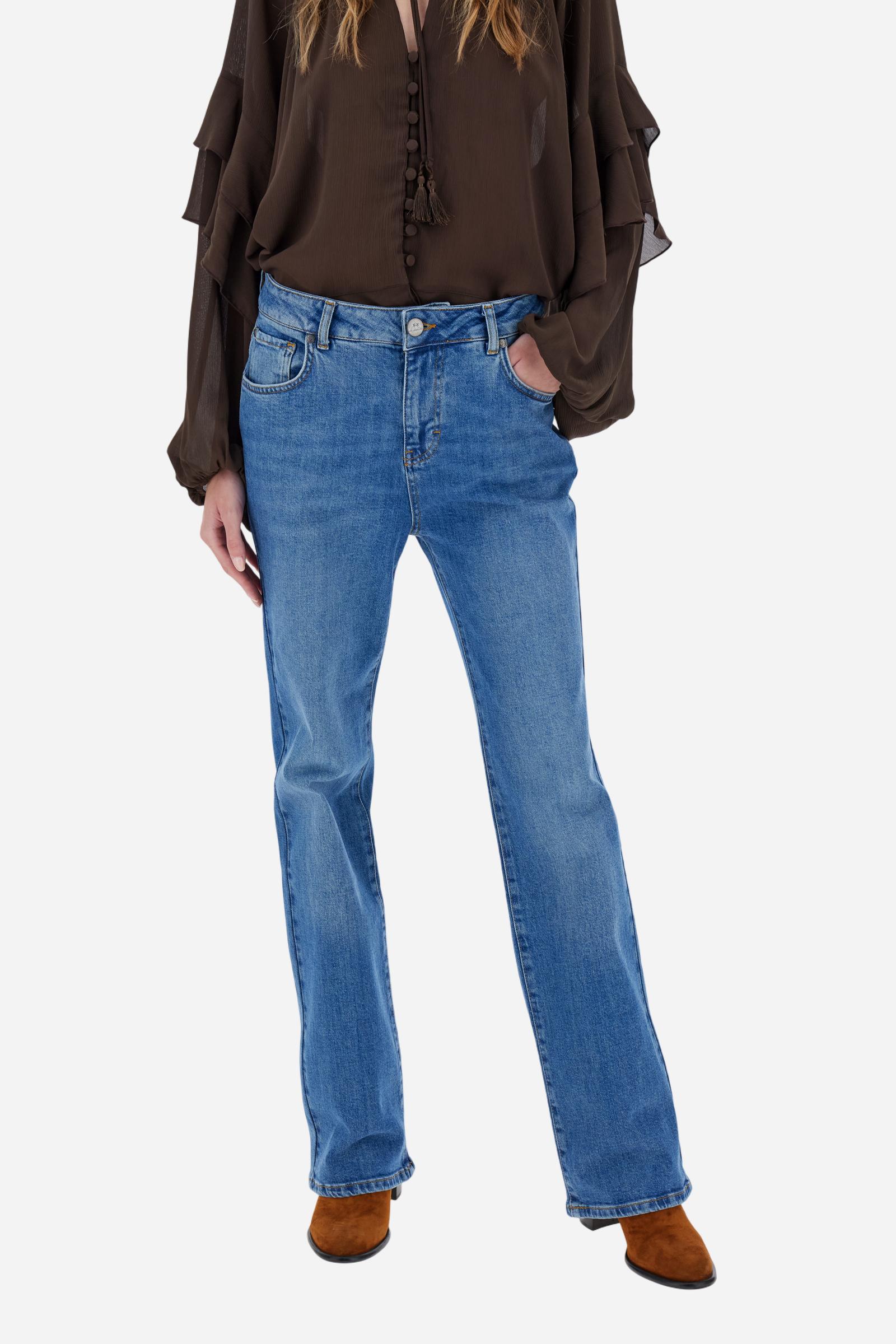 Women's stretch denim jeans. Classic 5-pocket style with regular fit and cigarette legs. The jacron label is applied to the back of the waistband, where the brand logo appears. The model is wearing a size 28. - Medium Indigo Denim
