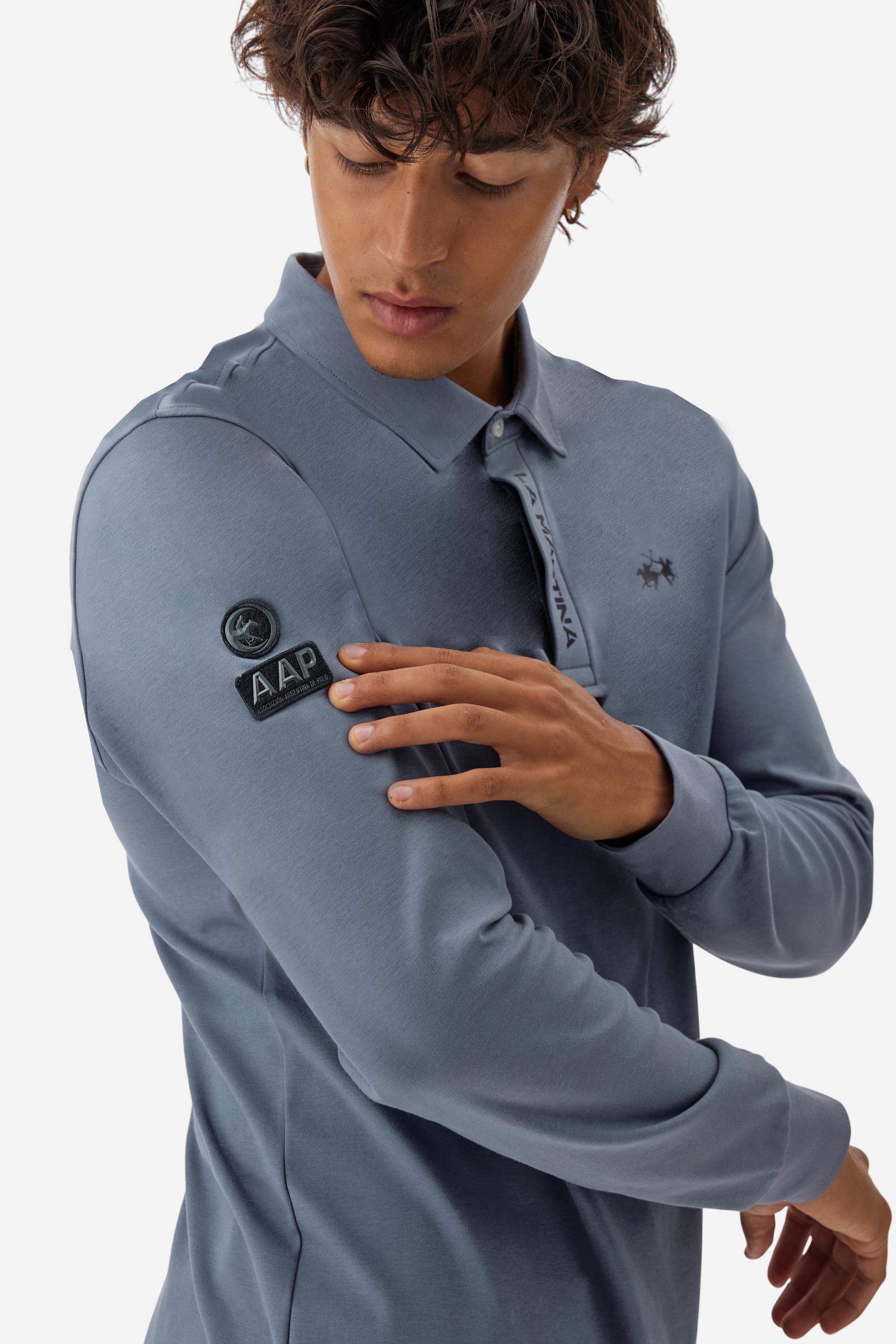 Premium men’s long-sleeve polo shirt in 100% cotton jersey with a smooth, silky texture. Hidden button placket and vertical contrast print. Patches dedicated to the Asociación Argentina de Polo (AAP) on the sleeve and below the opening. Small semi-transparent contrasting logo printed on the chest. Regular fit. The model wears size L. - Flint Stone