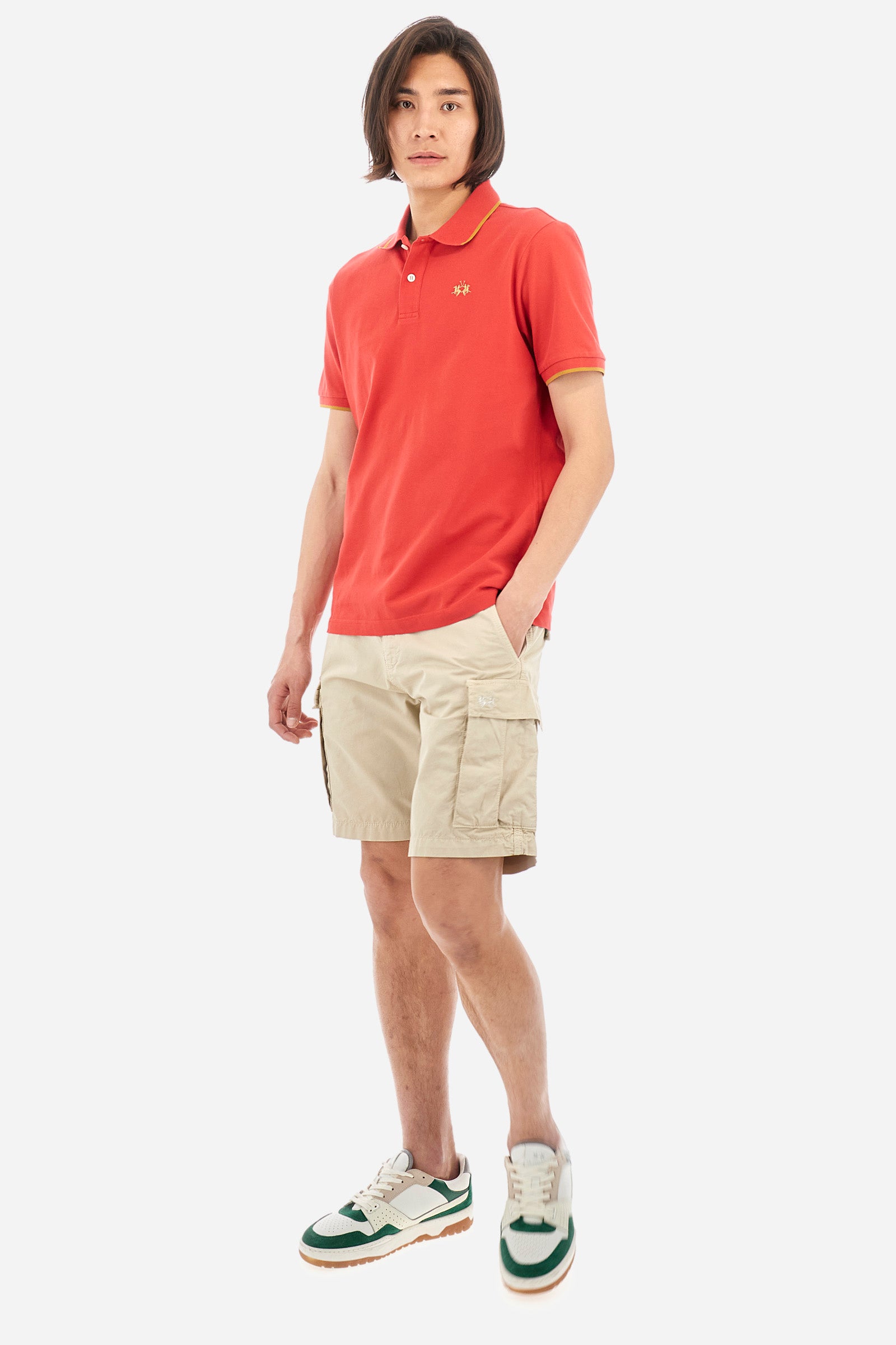 Men’s polo with short sleeves in stretch pique cotton. A classic La Martina, with a simple and linear style. The regular fit fits easily to any type of silhouette. A small La Martina logo is embroidered on the chest, in contrasting shades like the sleeve edge. The model is 187 cm tall and wears a size L. - Poinsettia