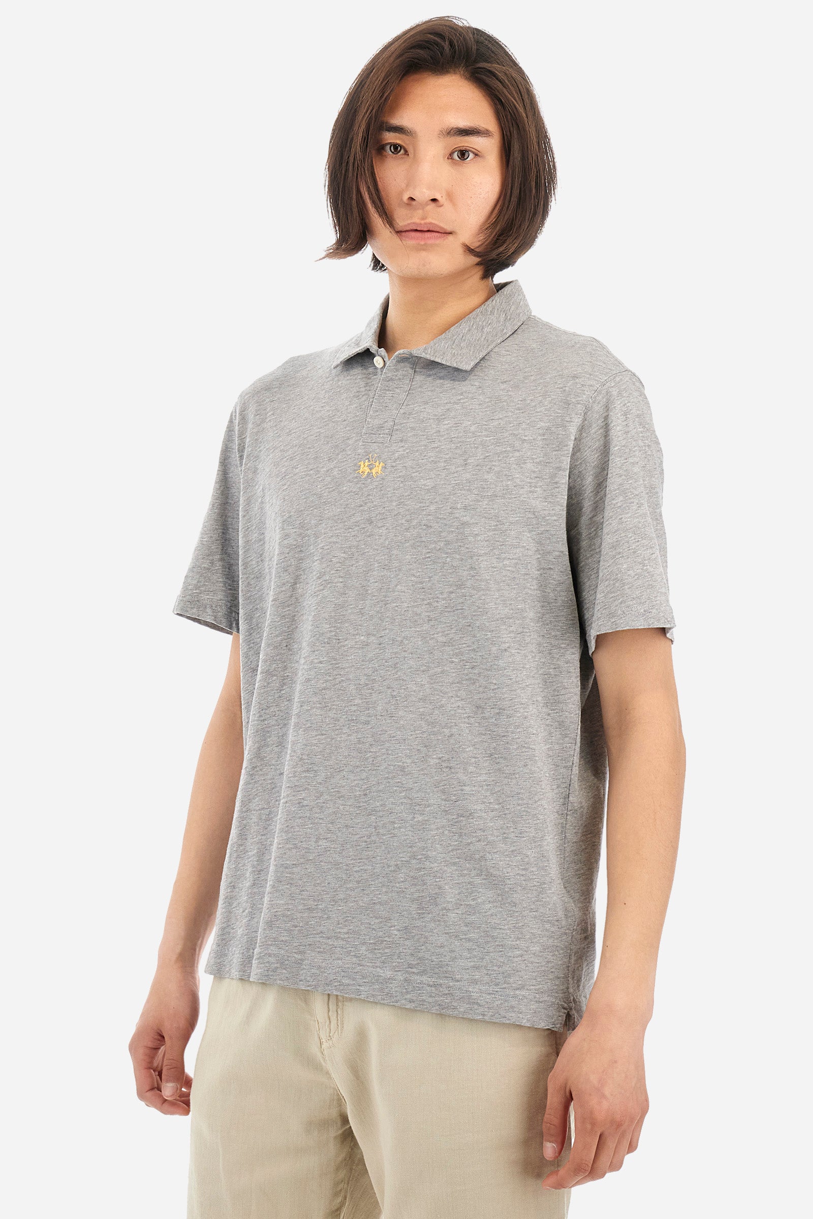This is the iconic Polo 19-42 from La Martina. Men's short-sleeved polo shirt in solid color made of 100% slub jersey. With a regular fit, it has a collar and a double button closure while the La Martina logo is embroidered in small gold on the front under the placket. Ideal when worn with denim from the collection. Each Polo is kept in an exclusive logoed envelope and is accompanied by a certificate of guarantee. The model is 187 cm tall and wears a size L. - Light Heather Grey