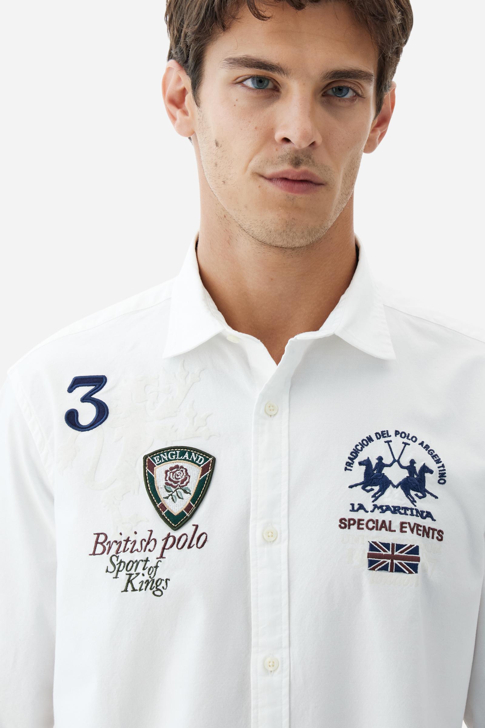 Classic men's long-sleeved shirt in stretch cotton Oxford, solid colour. Finished with a French collar and interior regimental-pattern fabric details. Chest features multicolour prints and embroideries inspired by British Polo, including the large team logo embroidered in contrast. Regular fit ensuring comfort and enhancing any physique. Model wears size L. - Optic White