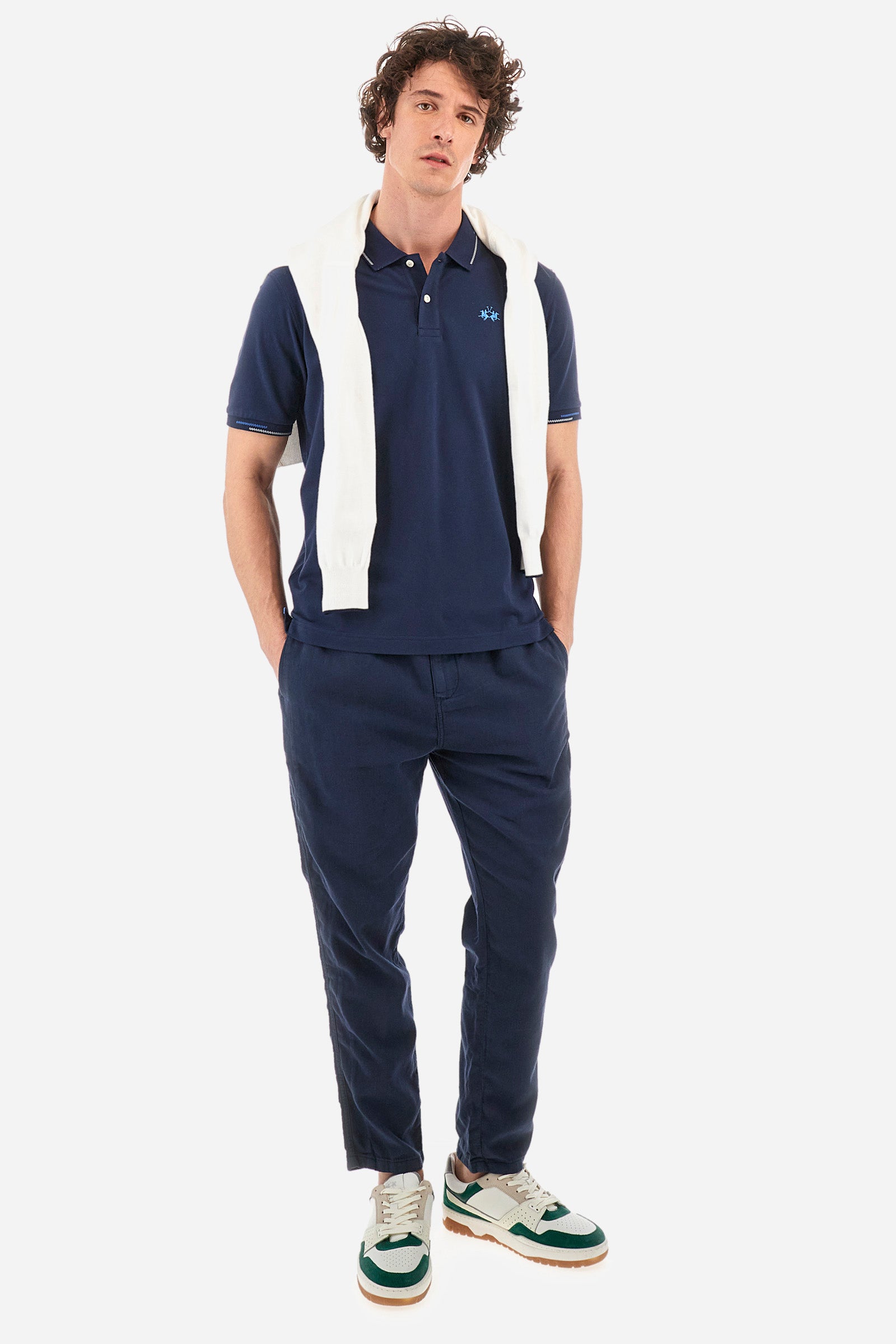 Men's single-colour short-sleeved polo in elasticated cotton. Two-button fastening. Ribbed collar and armholes with a stripe in different shades. Featuring a small logo embroidered on the chest. The fit is regular. The model wears a size L. - Navy