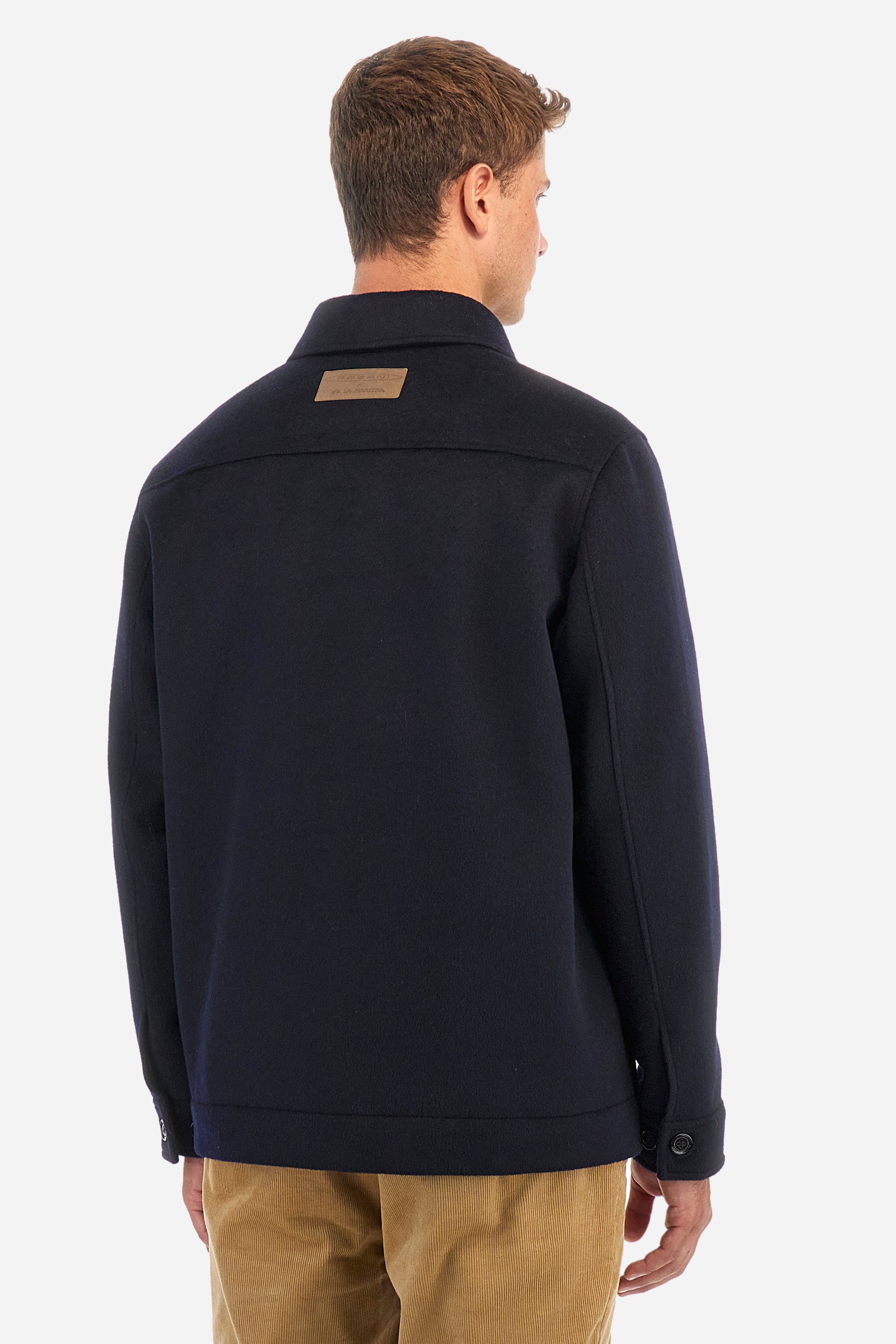 Men's single-colour Pagani jacket with suede effect and long sleeves. Made of wool and cashmere. Pointed collar and button fastening. There is an open pocket on the chest. La Martina lettering can be found on the patch on the back. Regular fit. The model is wearing a size L. - Navy