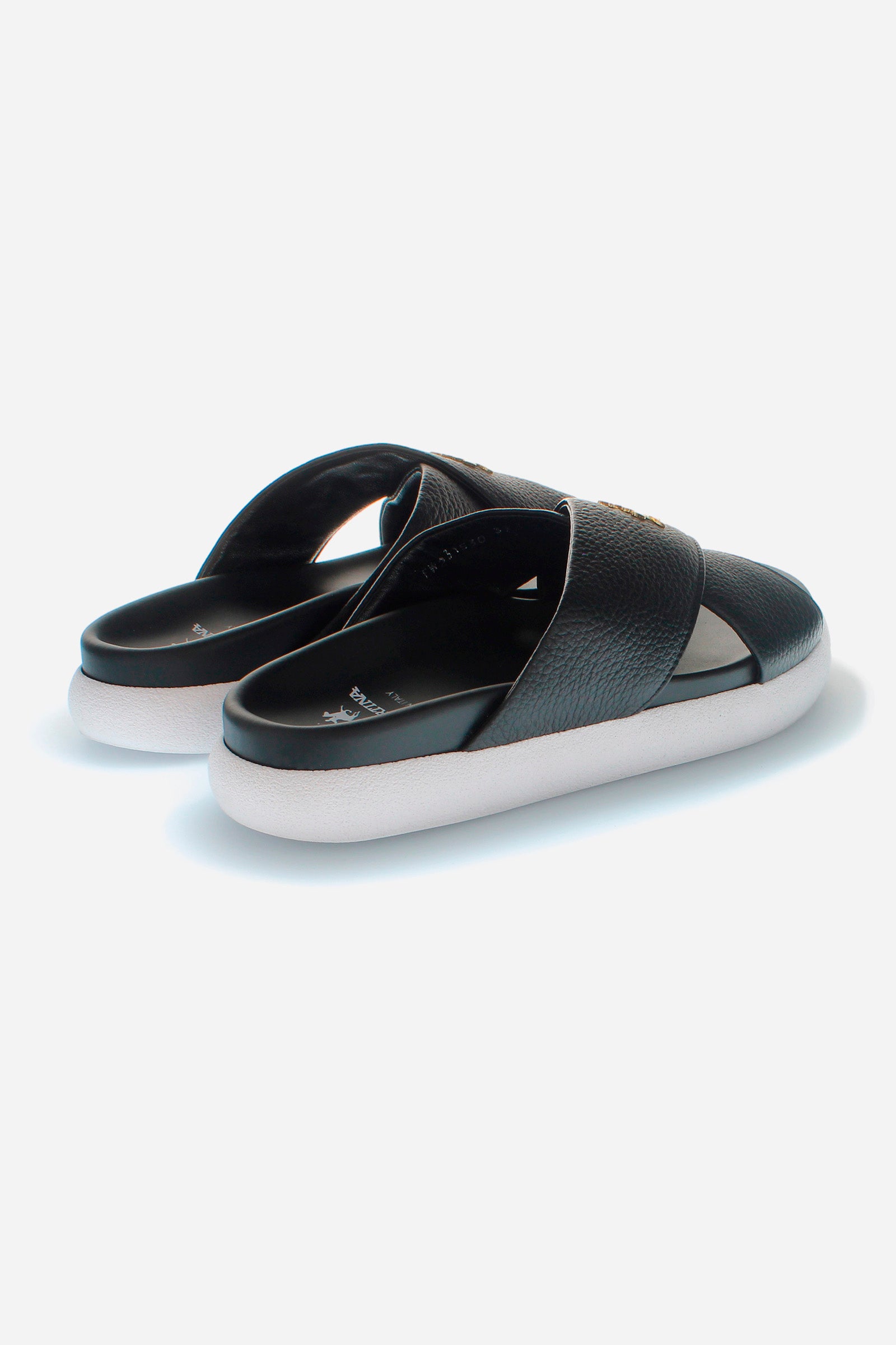 Women's sandal in soft tumbled leather, made with two wide crossed bands on the front and embellished with the La Martina figure logo in golden metal. The bottom is in non-slip and waterproof PU, which gives a comfortable and secure fit. To be combined with a summer look, to create the right mix of elegance and comfort. - BLACK