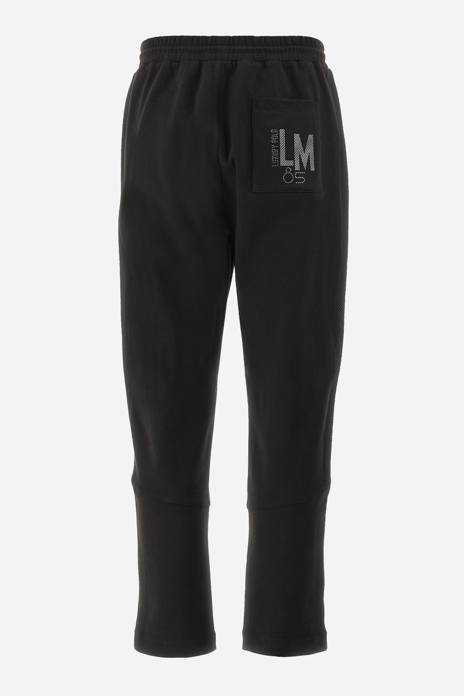 Men's single-colour jogging bottoms in mixed cotton. Drawstring at the waist and double welt pocket on the front. Featuring a side stripe with a honeycomb texture. On the back there is a single open pocket featuring the brand's initials. The fit is regular. The model wears a size L. - Black