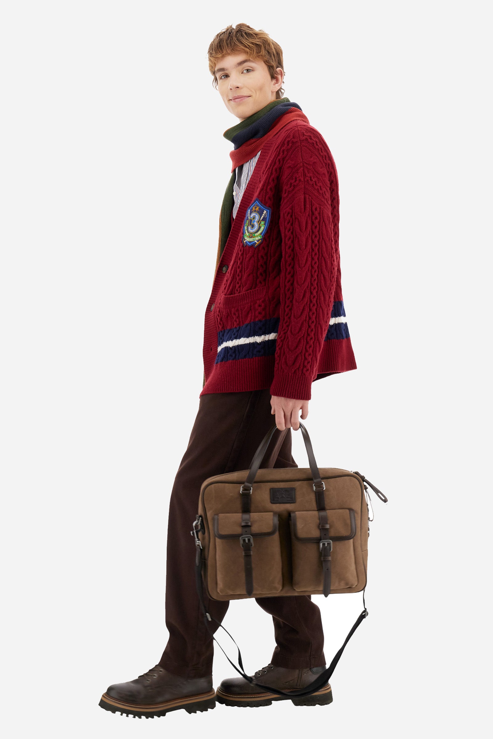 Men’s cardigan with long sleeves in solid-colour lambswool with cable-knit pattern for a refined and classic look. Deep neckline, ribbed cuffs and hem, closure with personalised horn-effect buttons. Applied front pockets and bicolour bands on the hem reflecting the chest patch colours. Oversized fit with dropped shoulders for a modern silhouette. The model wears size L. - Chili Pepper