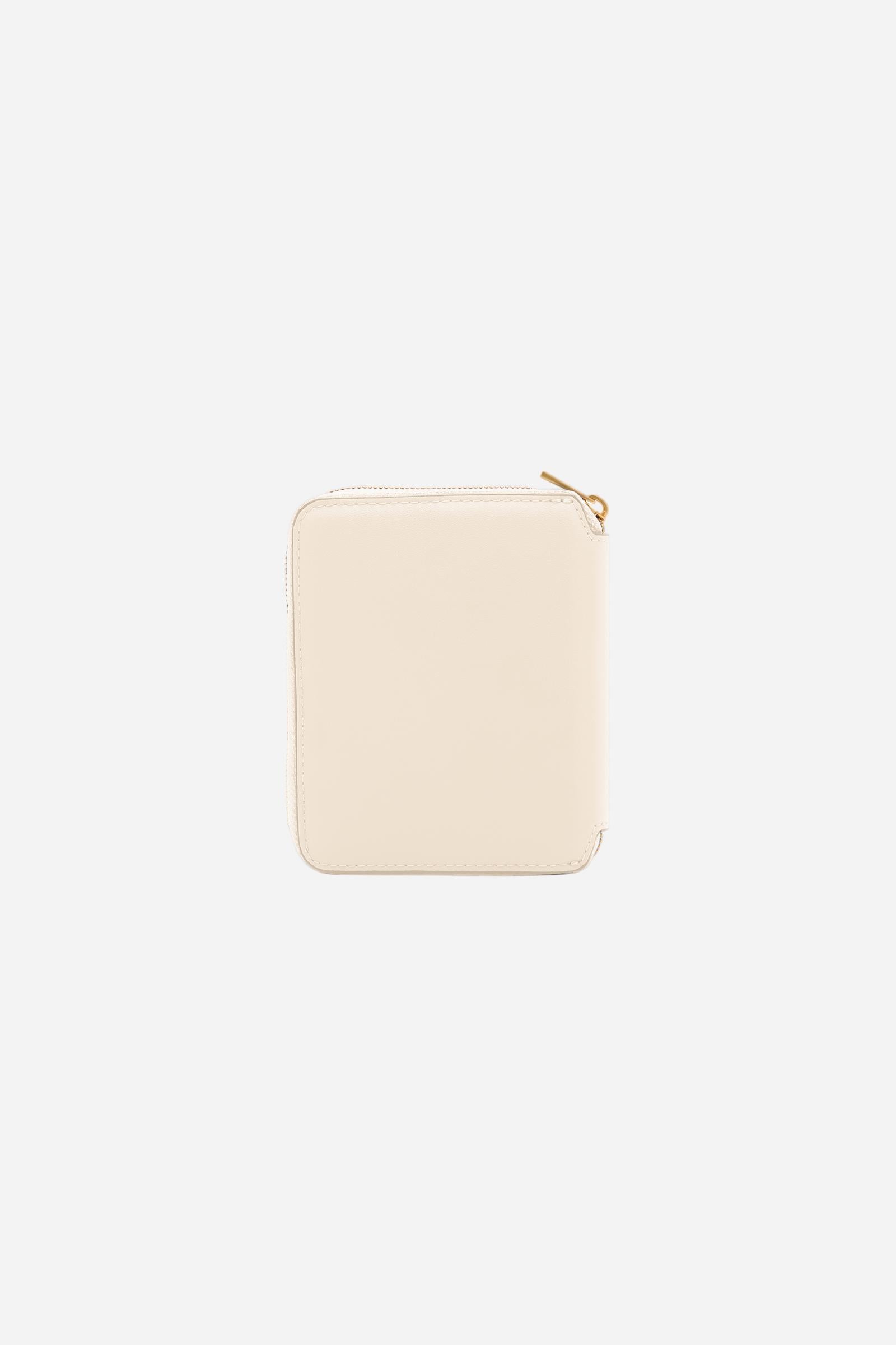 Small zip around wallet in calfskin leather. Compact and practical, with golden zip and branded metal detail. - SILK