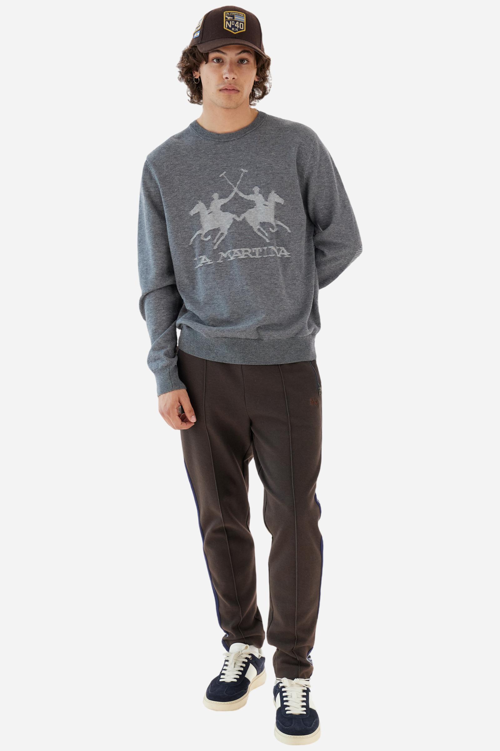 Men’s joggers made of 100% cotton interlock fleece with a bicolor design. Elastic waistband with drawstring for a customizable fit. Two zipped side pockets add practicality, while multicolor striped tape decorates both sides. A vertical crease on the front leg adds refinement to this sporty style. Small embroidered logo in contrast under the left pocket. Regular straight-leg fit for a classic, comfortable silhouette. Model wears size L. - Java