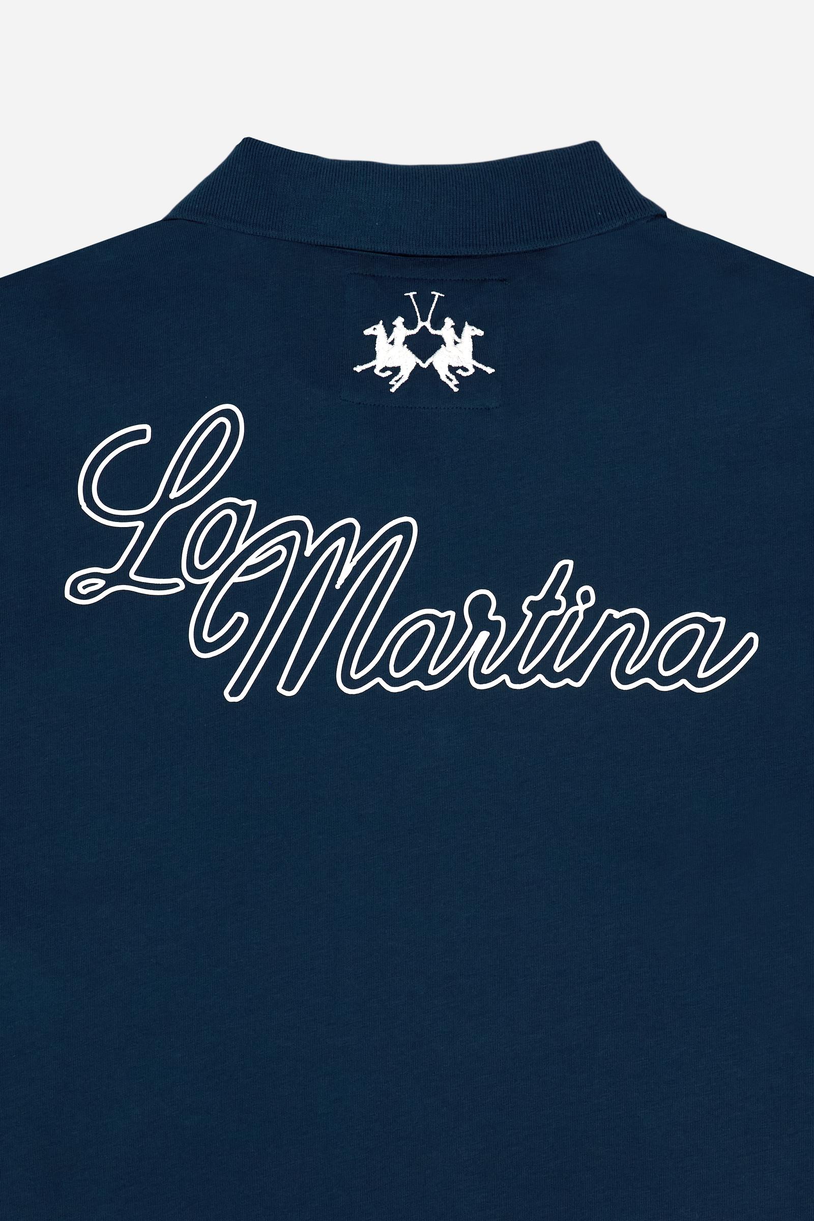 Men’s short-sleeve cotton piqué polo. Two-button placket and contemporary fit, featuring an applied shield patch on the chest and large lettering on the back. - Navy