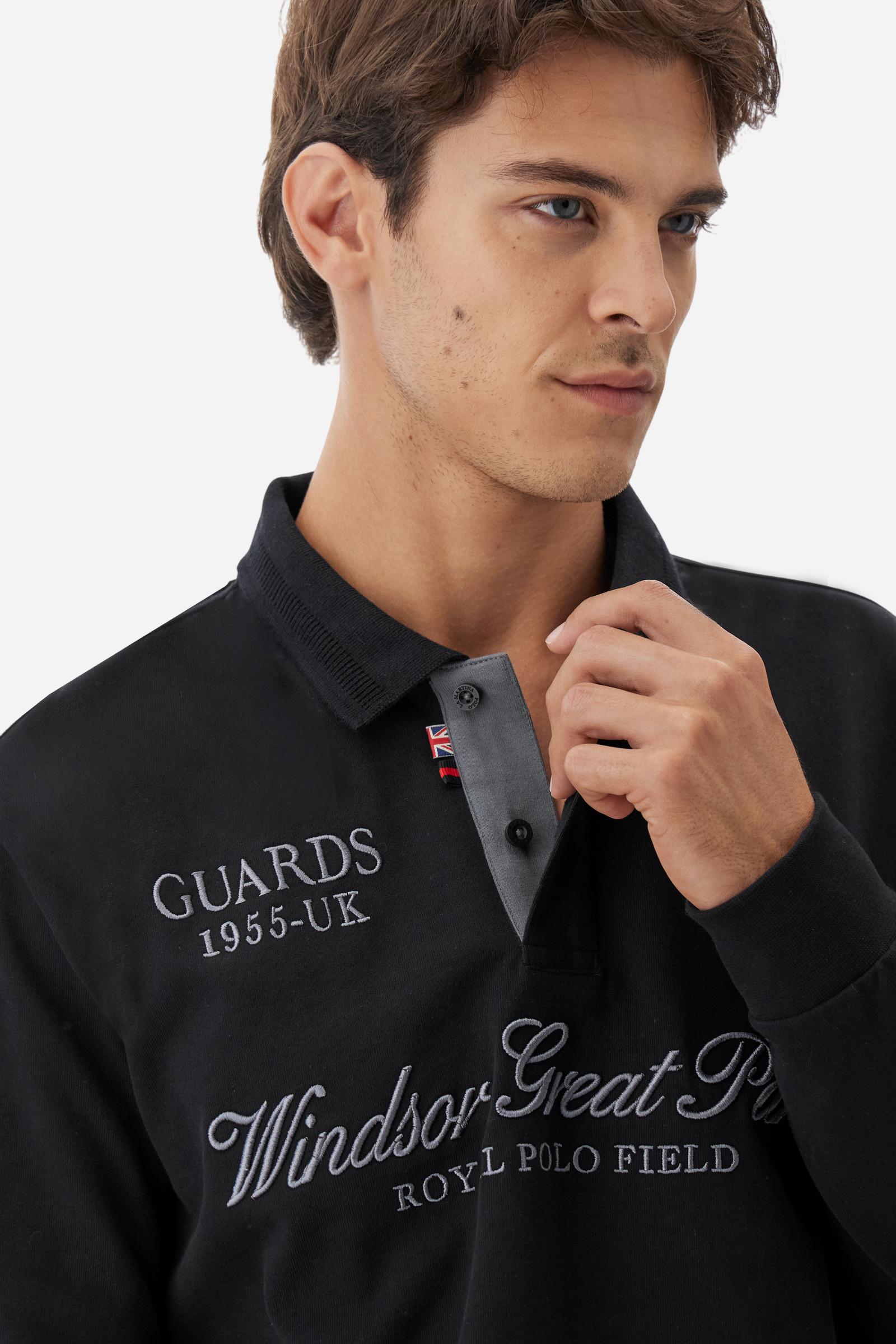 Long-sleeve polo shirt in warm cotton jersey. Ribbed collar with subtle textured detail, contrast undercollar and placket. Logo and Guards crest embroidered in contrast on the chest, paired with raised embroidered lettering inspired by Windsor tradition and British polo. Regular fit for an elegant yet relaxed style. Model wears size L. - Black