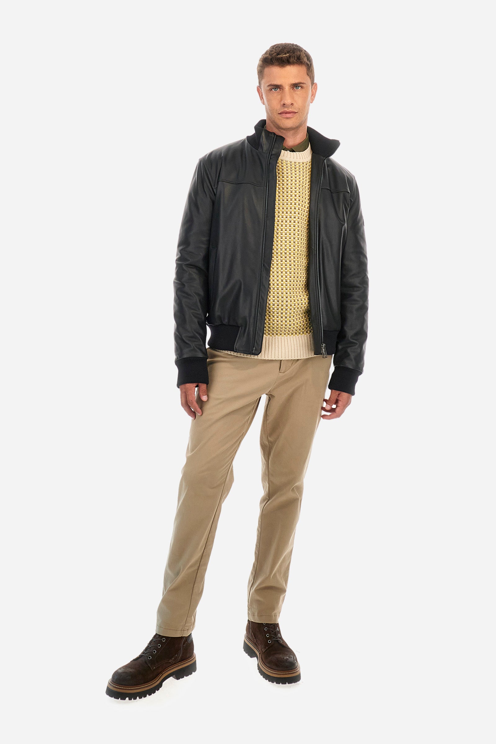 Men's crewneck pullover with long sleeves, made from a wool-blend yarn. The jacquard pattern differs on the front and sleeves, featuring a micro-check effect, while the back showcases a larger pattern with horizontal blocks. The collar, hem, and cuffs are in solid ribbed fabric. A patch inspired by Tierra del Fuego and a rubberized logo patch are applied on the sleeve. The fit is comfortable. - Jacquard Multicolour