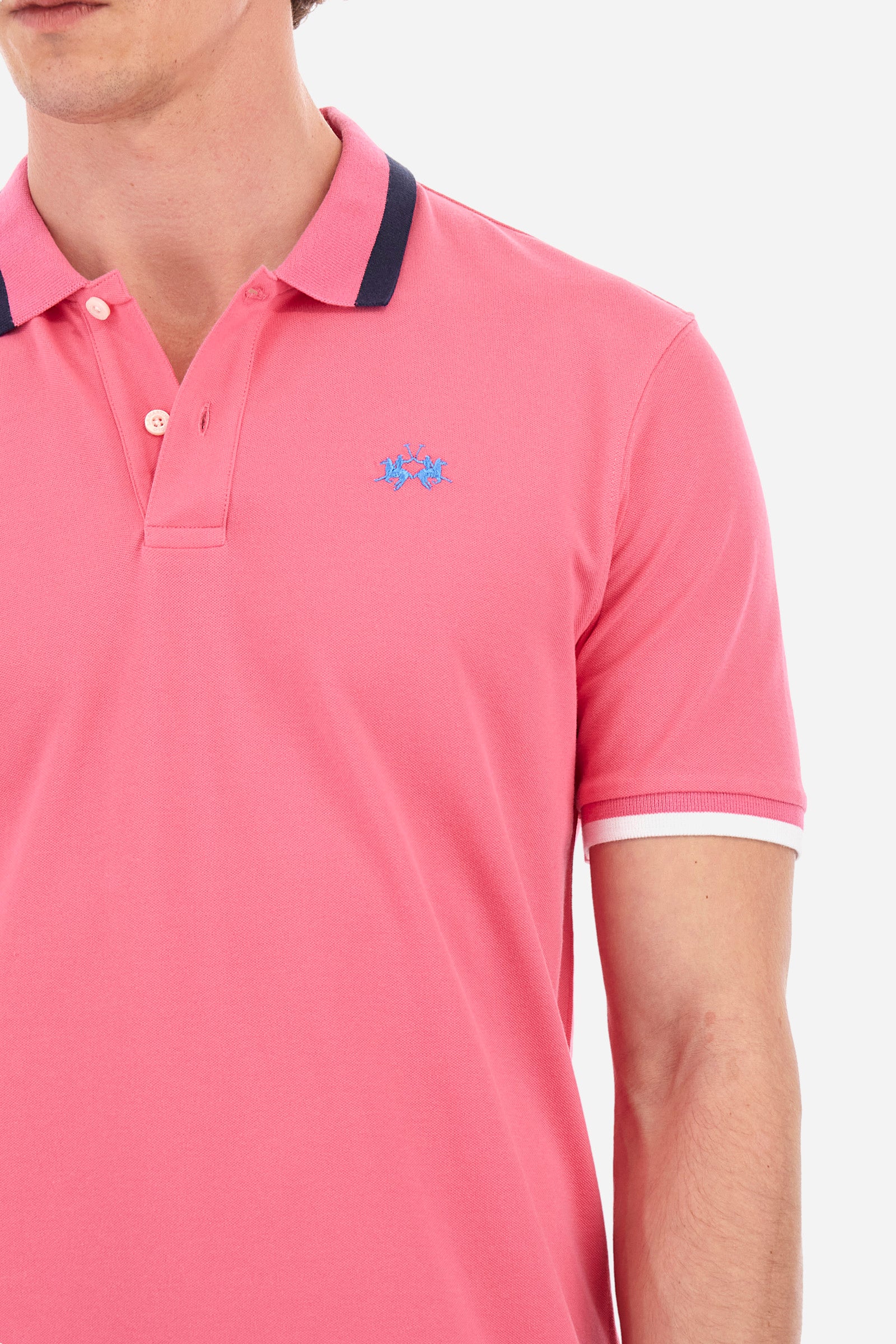 Men's single-colour short-sleeved polo in elasticated cotton. Two-button fastening. Ribbed collar and armholes with a stripe in different shades. The "La Martina" lettering can be found under the collar. Featuring a small logo embroidered on the chest. In a slim fit. The model wears a size L. - Hot Pink