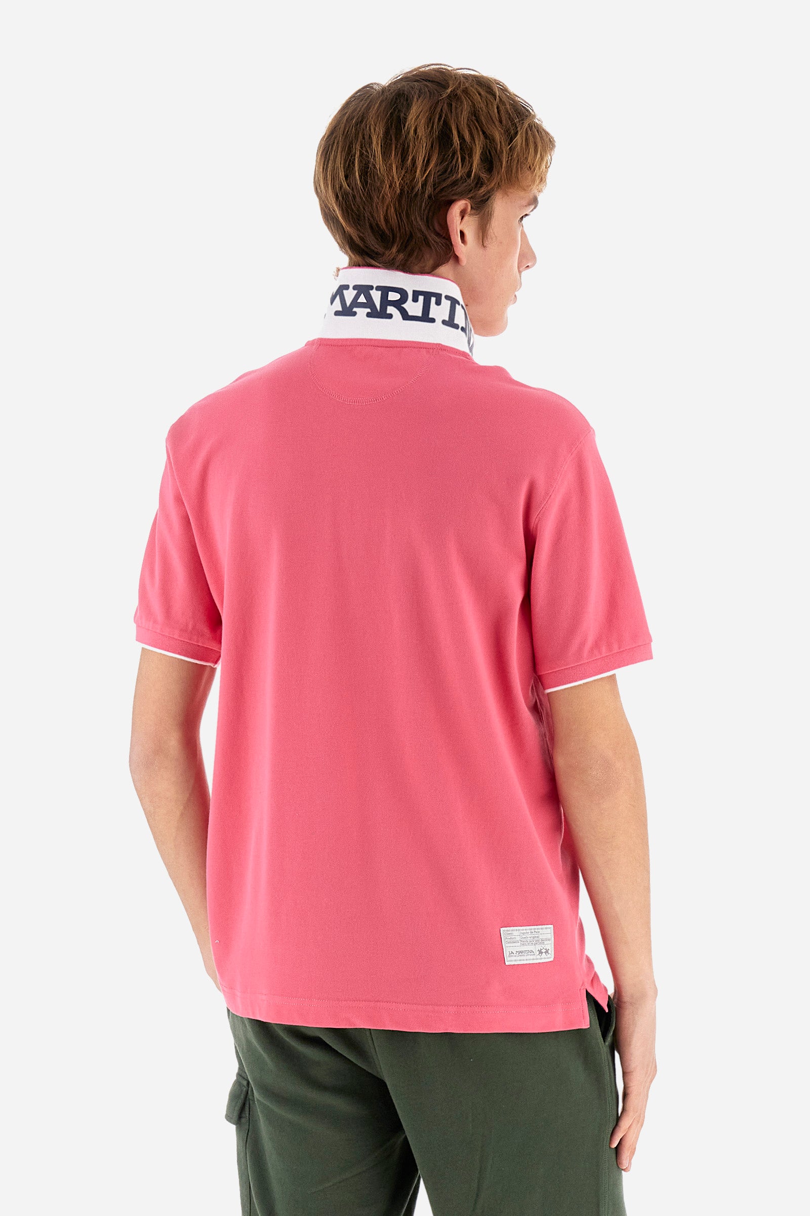 Men's plain short-sleeved polo shirt made from stretch piqué. Featuring a two-button fastening and a ribbon on the inside collar in contrasting coloured grosgrain. The collar and cuffs are in matching rib knit, with the undercollar also in rib knit but in a contrasting colour. The large logo is embroidered on the chest, left side with contrasting coloured thread. The undercollar features a print of the La Martina lettering in a contrasting colour. Regular fit. The model is wearing a size L. - Honey Suckle