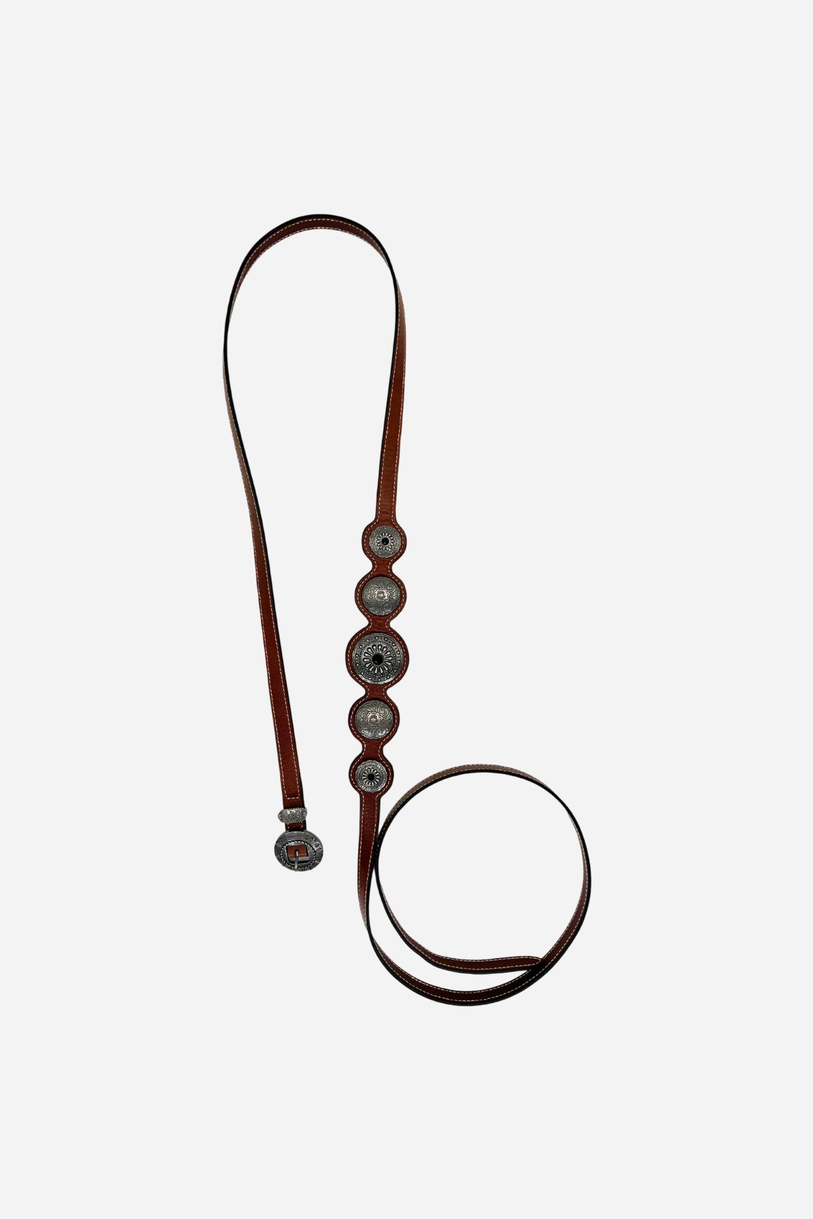 Full-grain leather women's belt with a unique wavy edge, adorned with engraved South American-inspired metal conchos and an antique-finished round buckle. - Cherry Mahogany